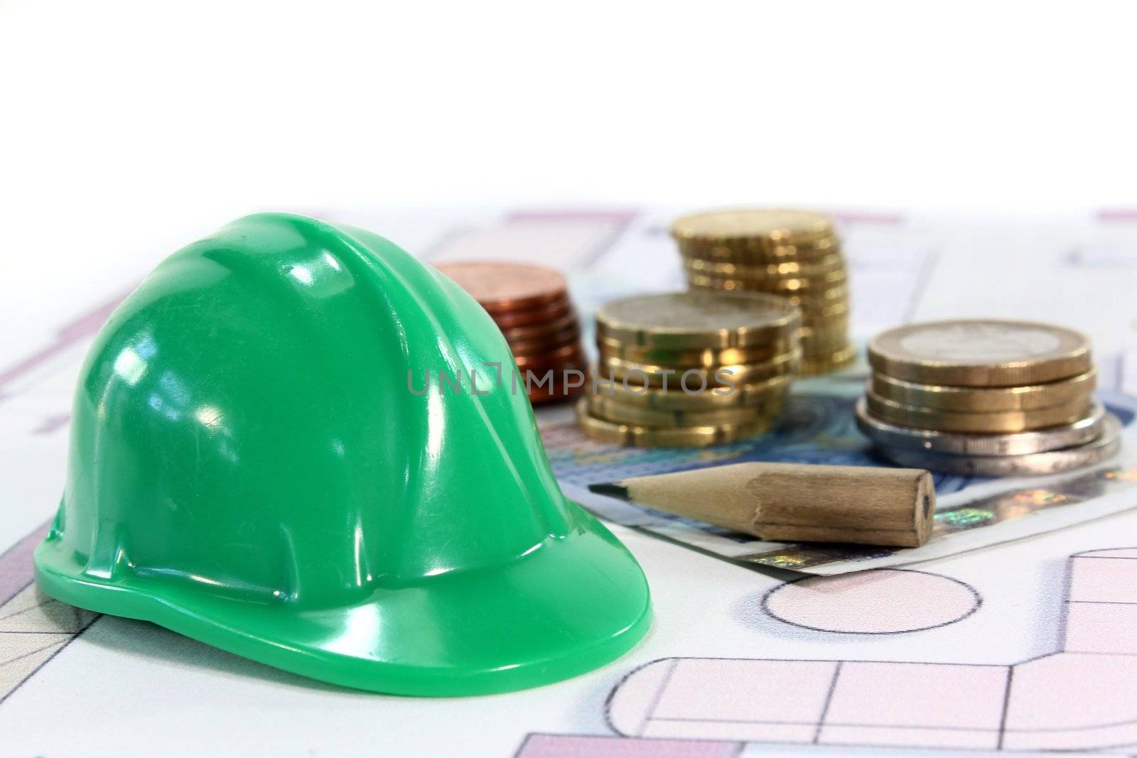 Construction helmet with euros on a housing plan