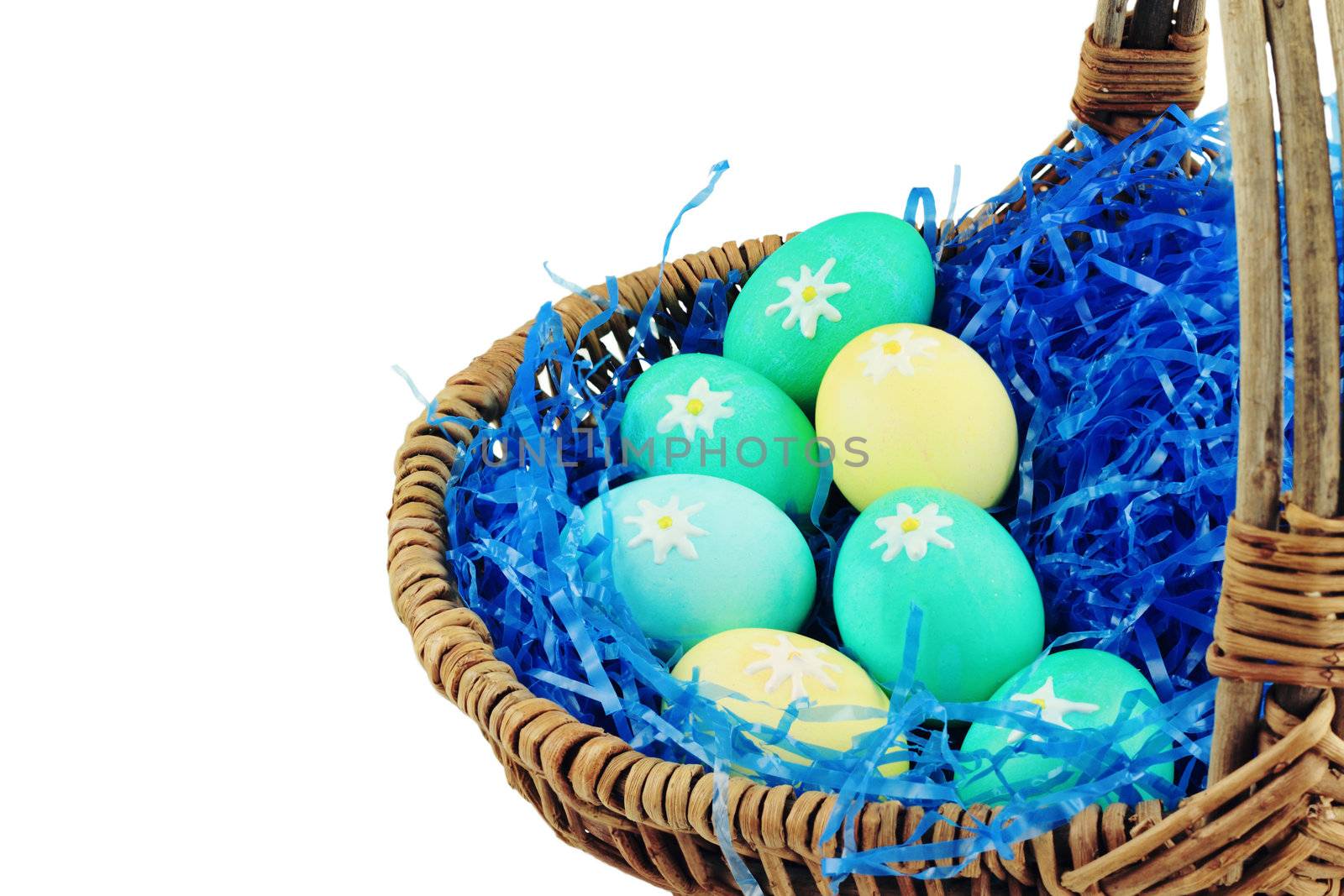 Basket with decorated Easter eggs isolated against a white background with room for copyspace. Shallow DOF.
