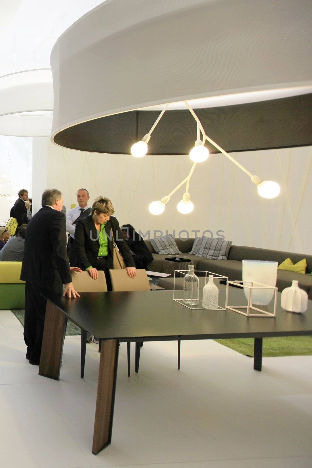 People visit interiors design stands and home architecture solutions at 2011 Salone del Mobile, international furnishing accessories exhibition in Milan, Italy.