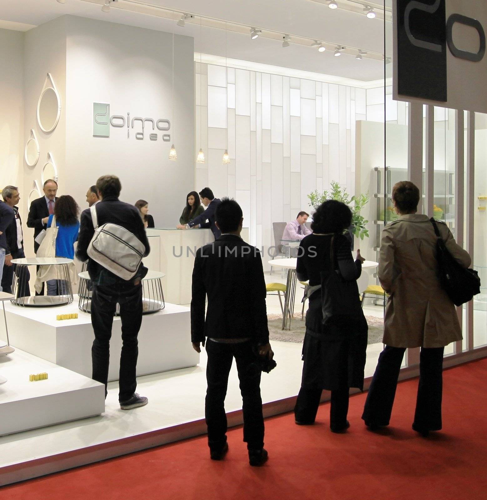 People visit interiors design stands and home architecture solutions at 2011 Salone del Mobile, international furnishing accessories exhibition in Milan, Italy.