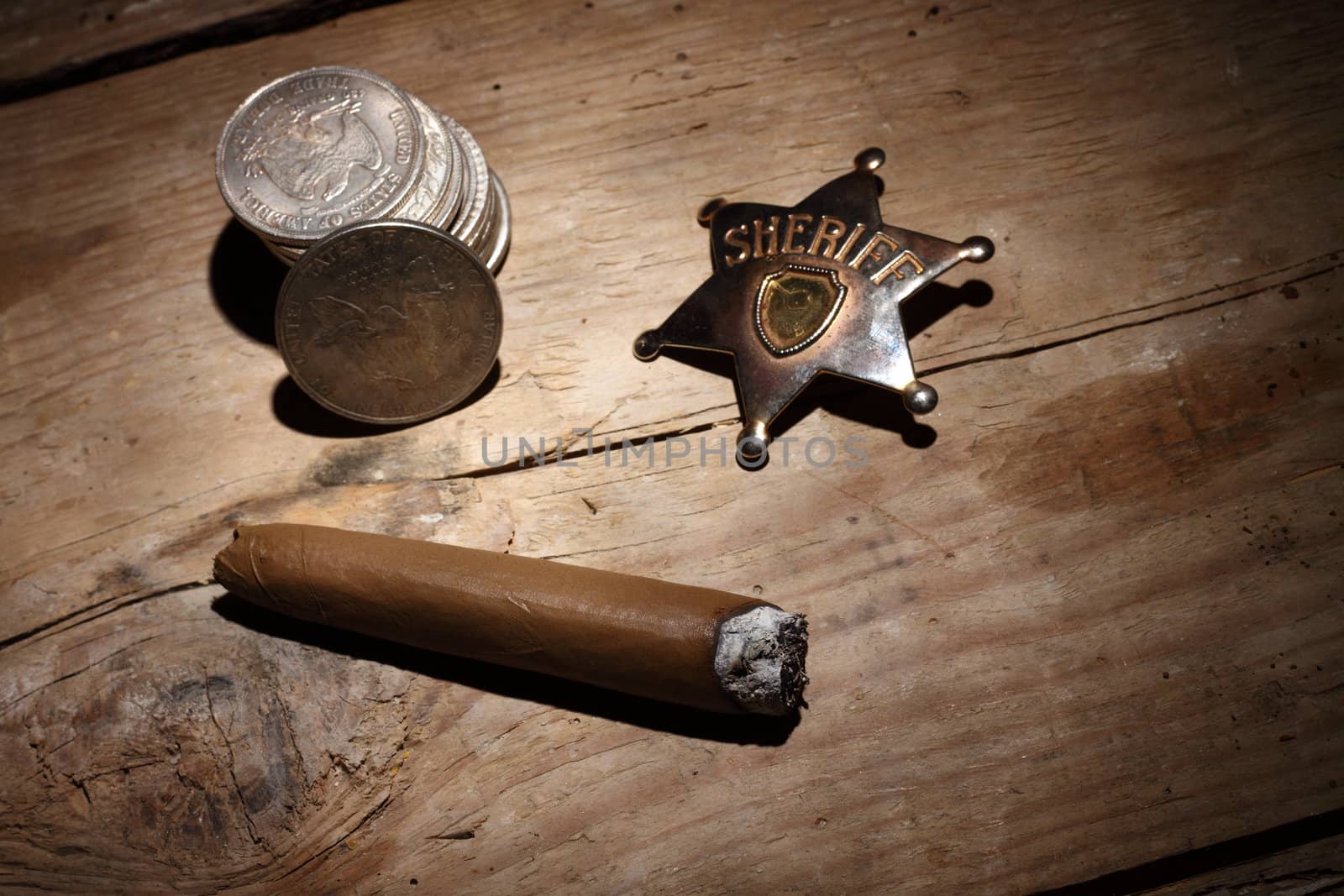 Cigar, badge  and pile of old silver coins