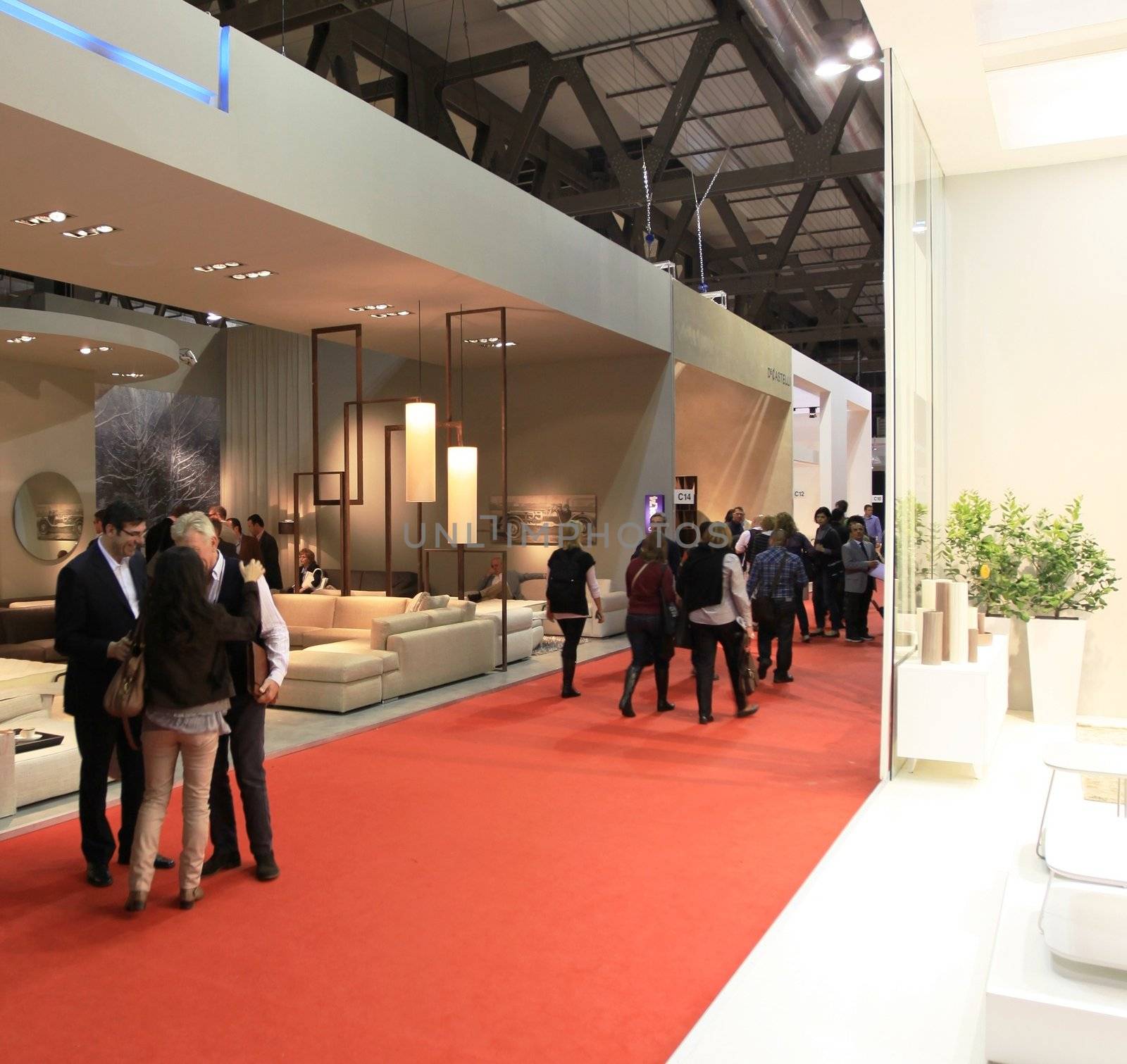 People visit interiors design stands and home architecture solutions at 2011 Salone del Mobile, international furnishing accessories exhibition in Milan, Italy.