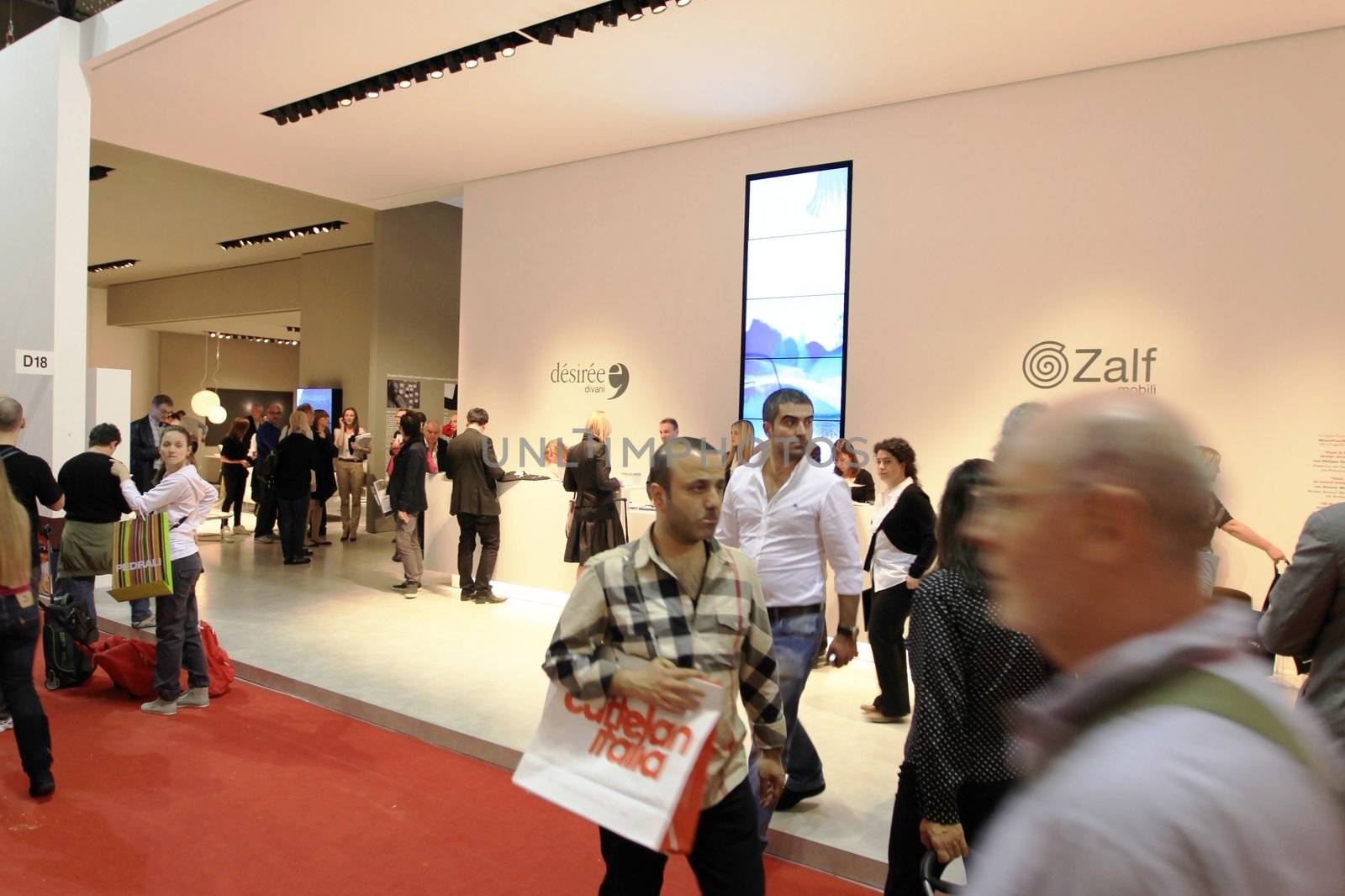 People visit interiors design stands and home architecture solutions at 2011 Salone del Mobile, international furnishing accessories exhibition in Milan, Italy.