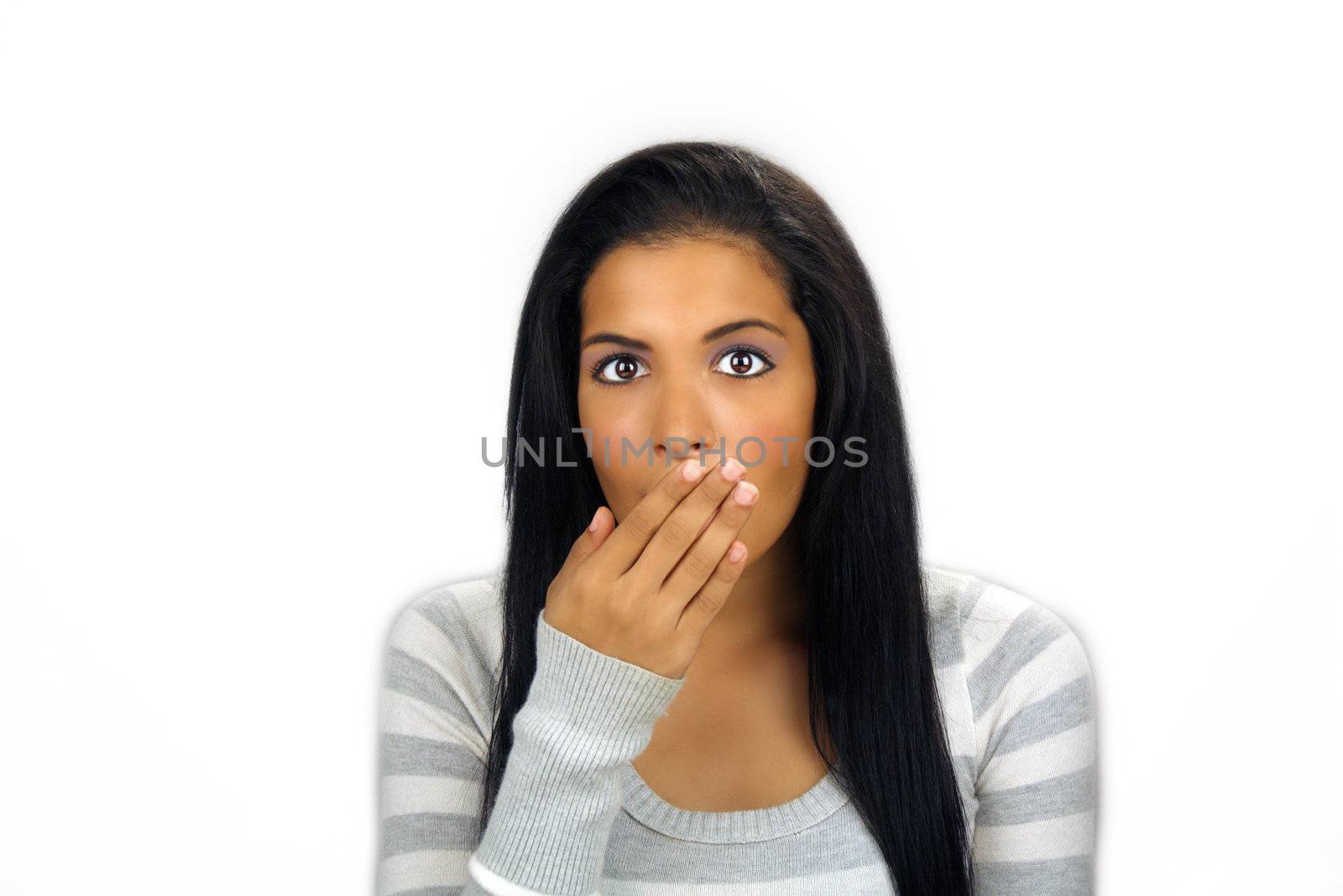 A lovely teenage Latina with long, luscious black hair holds her hand in front of her mouth, apparently shocked or embarrassed.