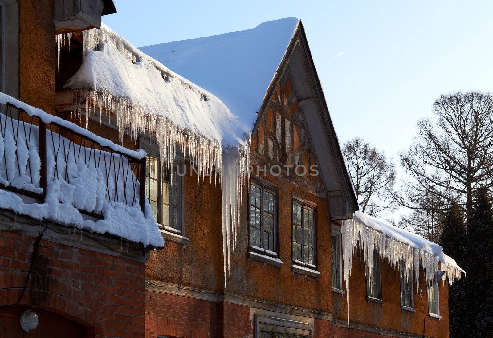 Windows Beneath Icicles, roof of rural winter house