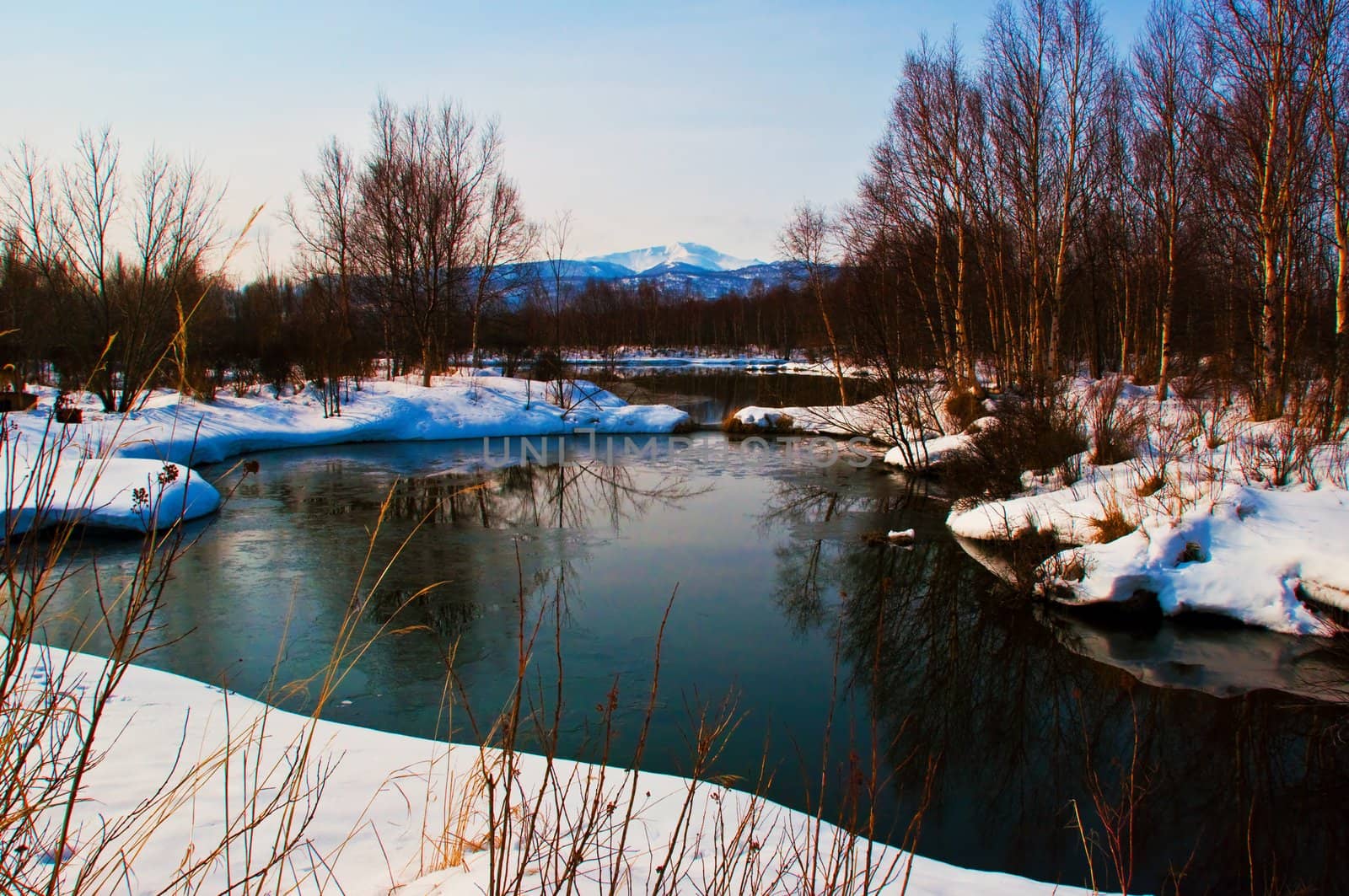 Nice winter lake scene with sun in the sky