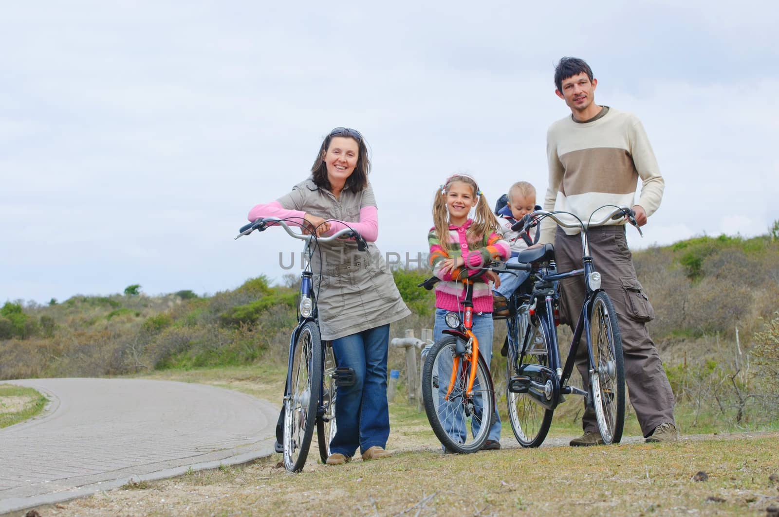 A family with children having a weekend excursion on their bikes