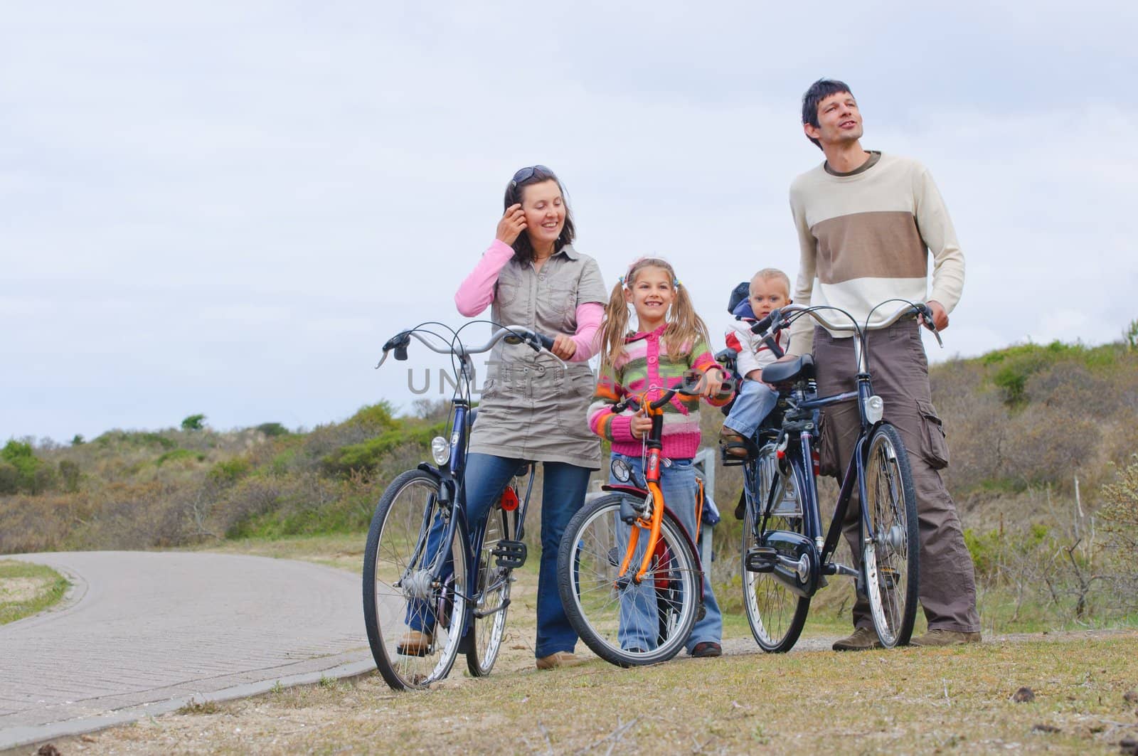 A family with children having a weekend excursion on their bikes