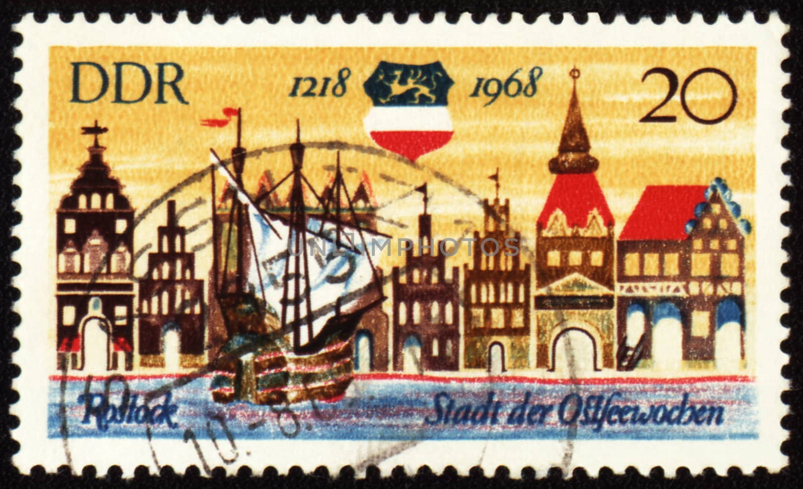 Old German town Rostock on post stamp by wander