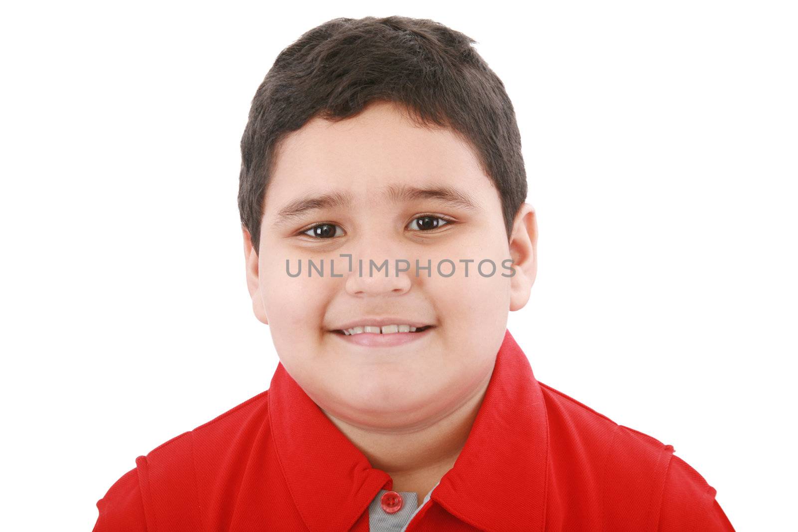 Boy looking at the camera with a small smile over white background