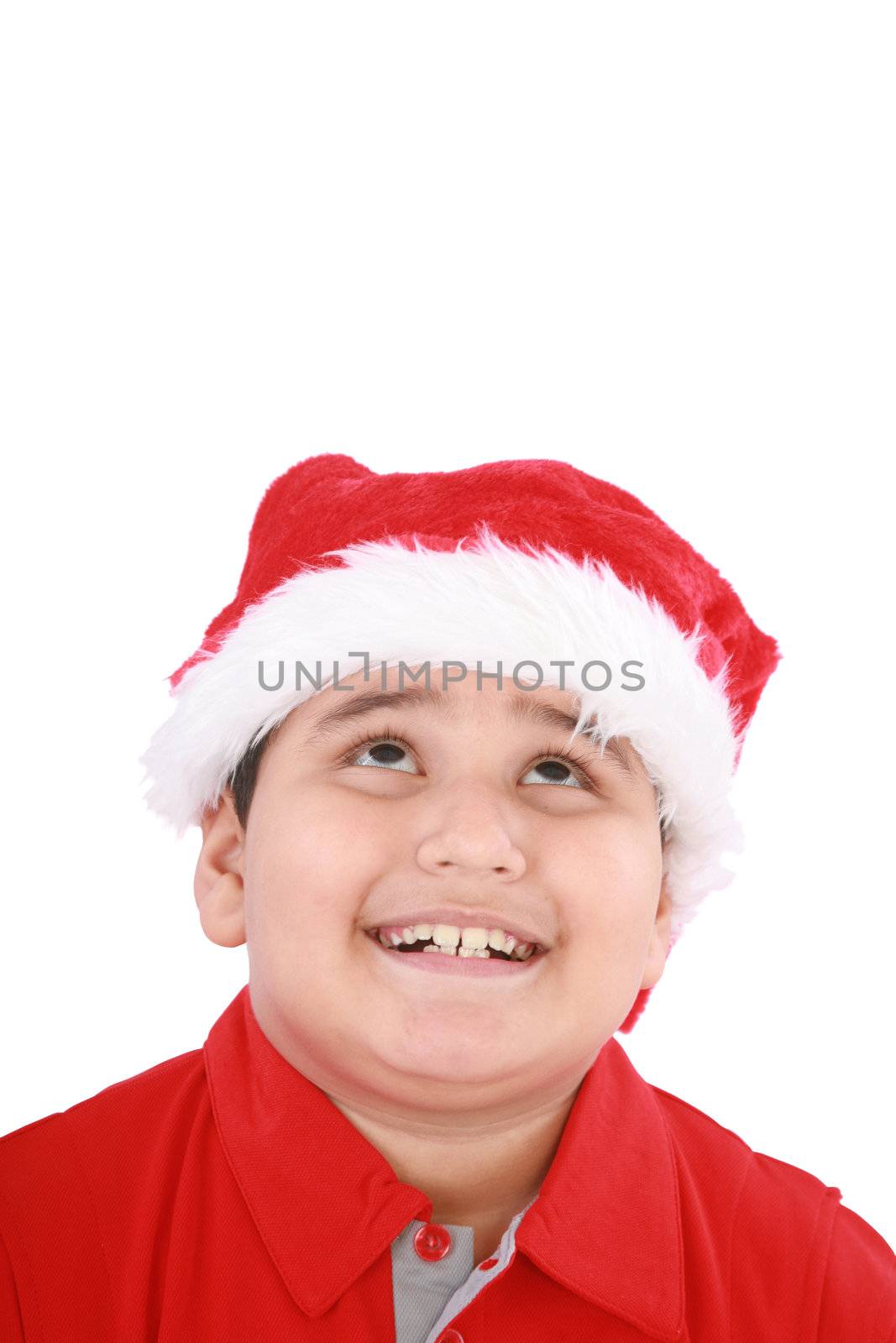 Head shot of young beauty Santa boy looking up to copy space and smiling