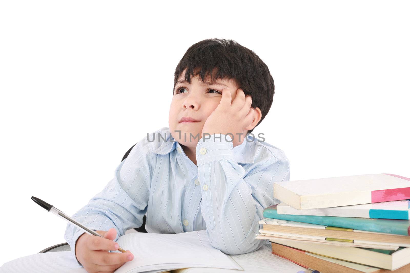 Upset schoolboy doing homework isolated on white