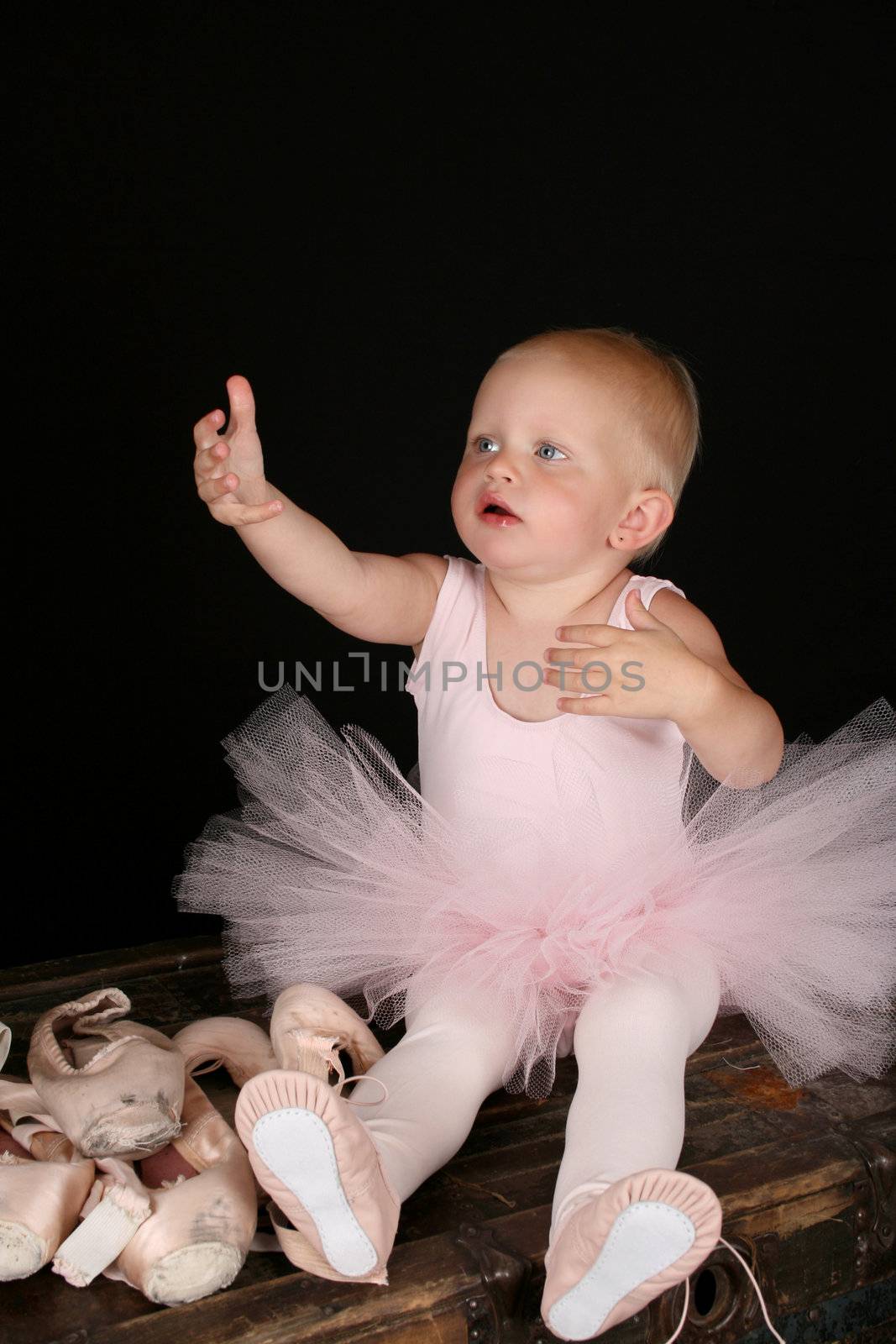 Cute baby ballerina wearing a pink leotard and tutu