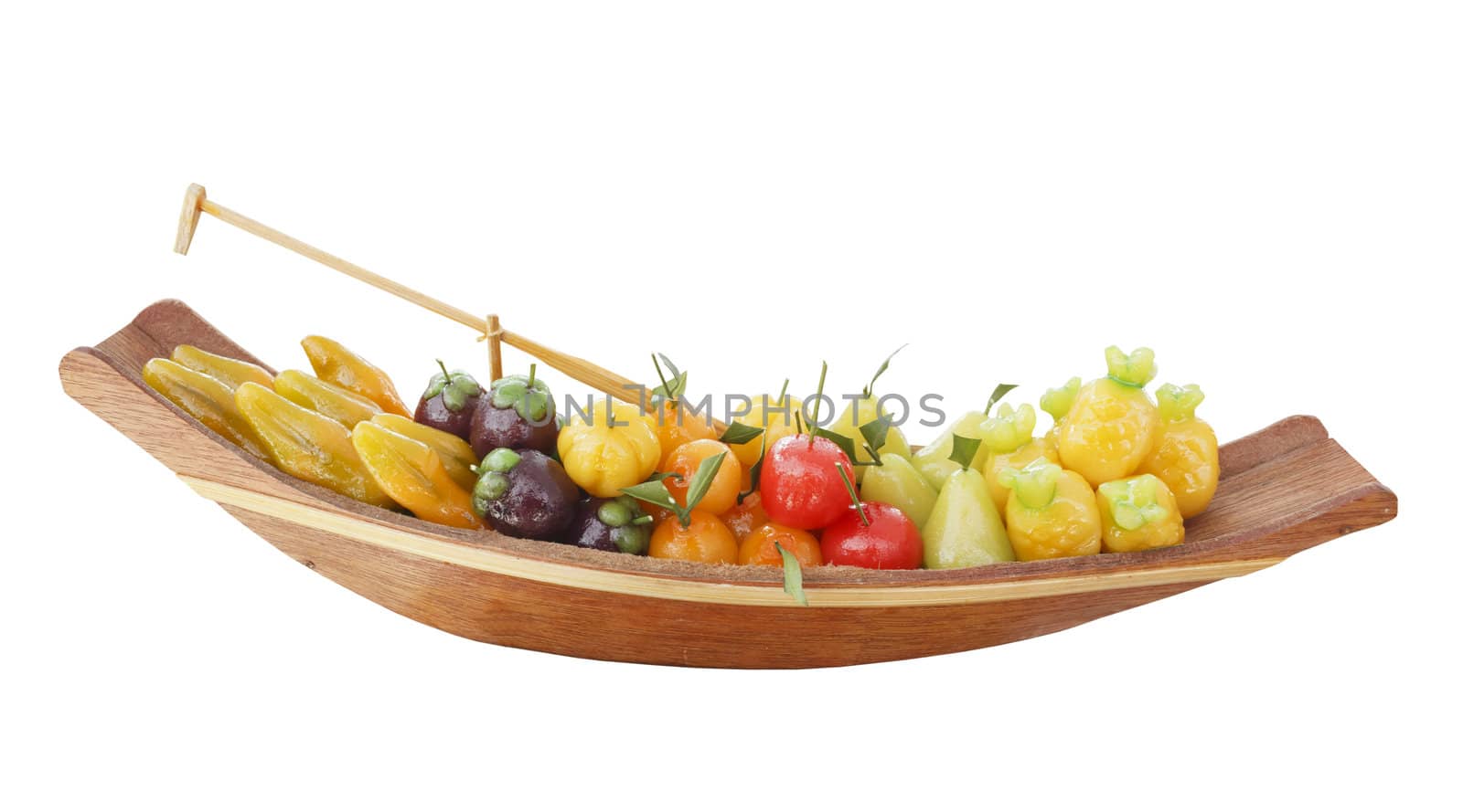 Isolated deletable imitation fruits arrangement in wood boat, Thai style dessert, inside coated with soy paste and jelly