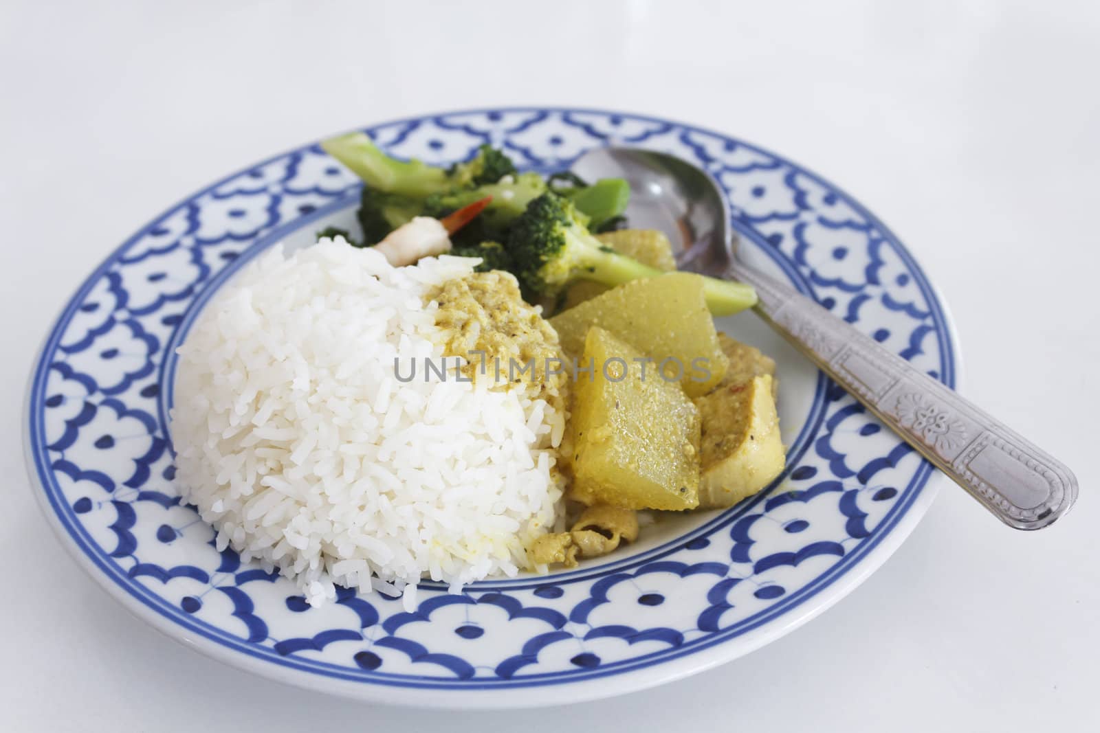 Thai food, boiled rice with spicy chicken breast and fried broccoli