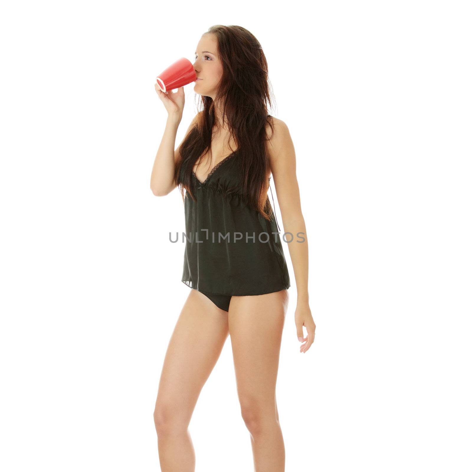 Morning woman in black lingerie with red mug isolated on white background