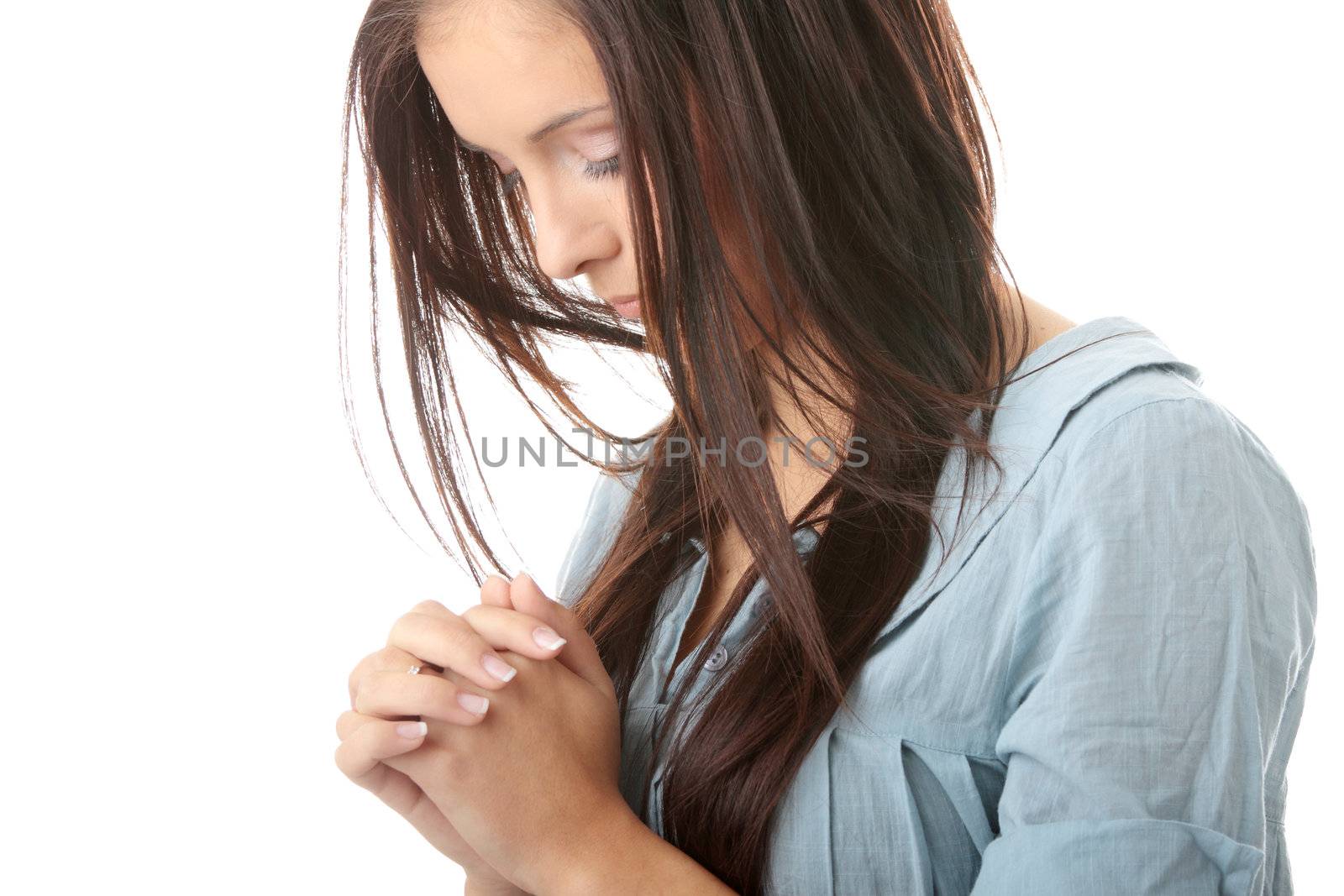 Closeup portrait of a young caucasian woman praying isolated on white background