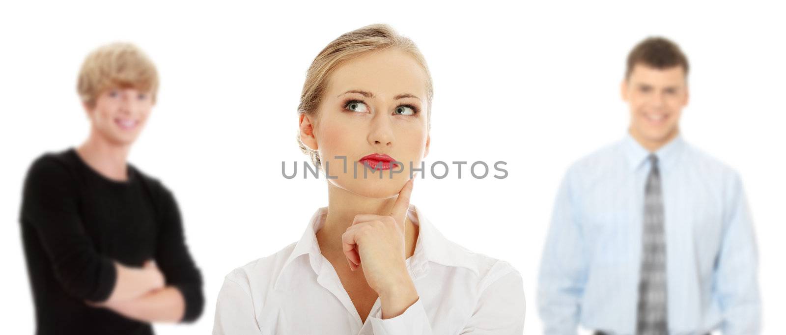 Thoughtful business woman looking right (making a choice) , isolated over a white background. Two young man in background