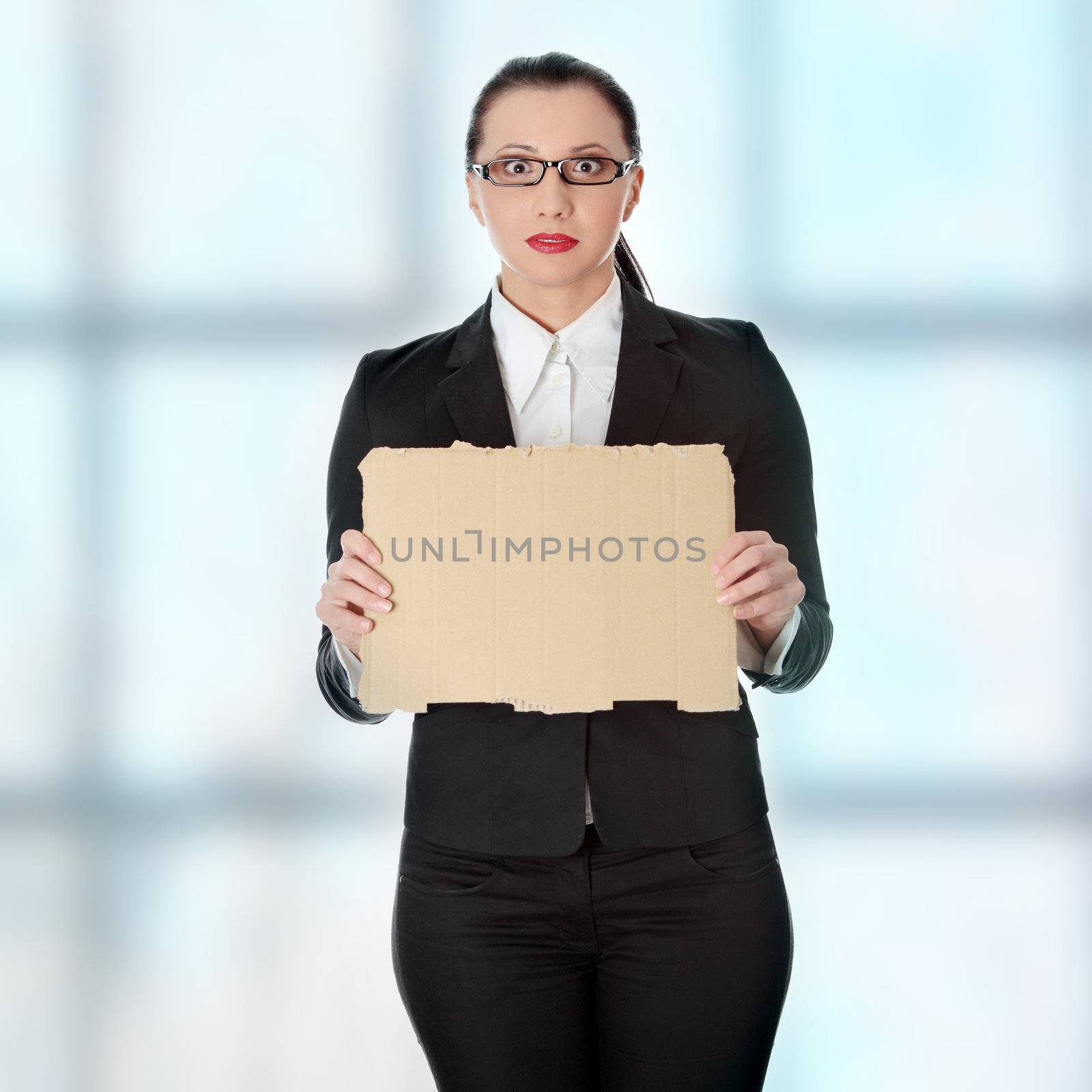 Unemployed businesswoman with empty cardboard sign by BDS