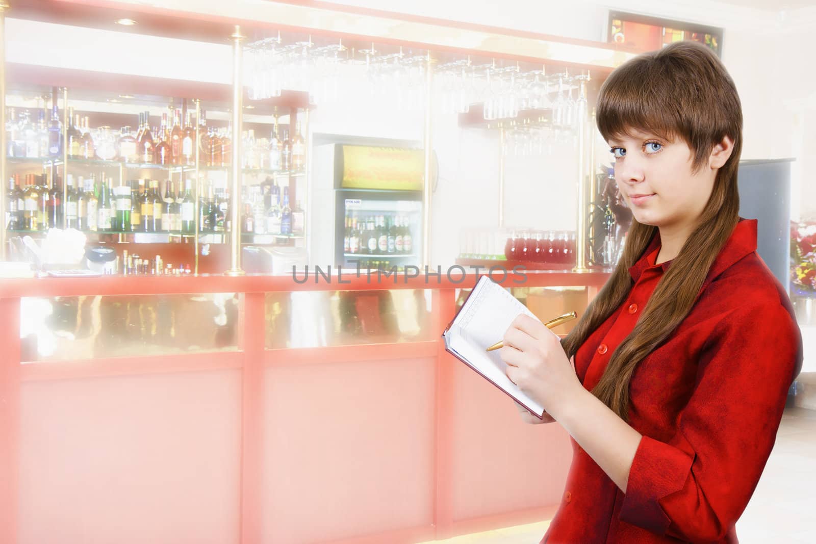 girl in red blouse with a notebook on the background of the bar
