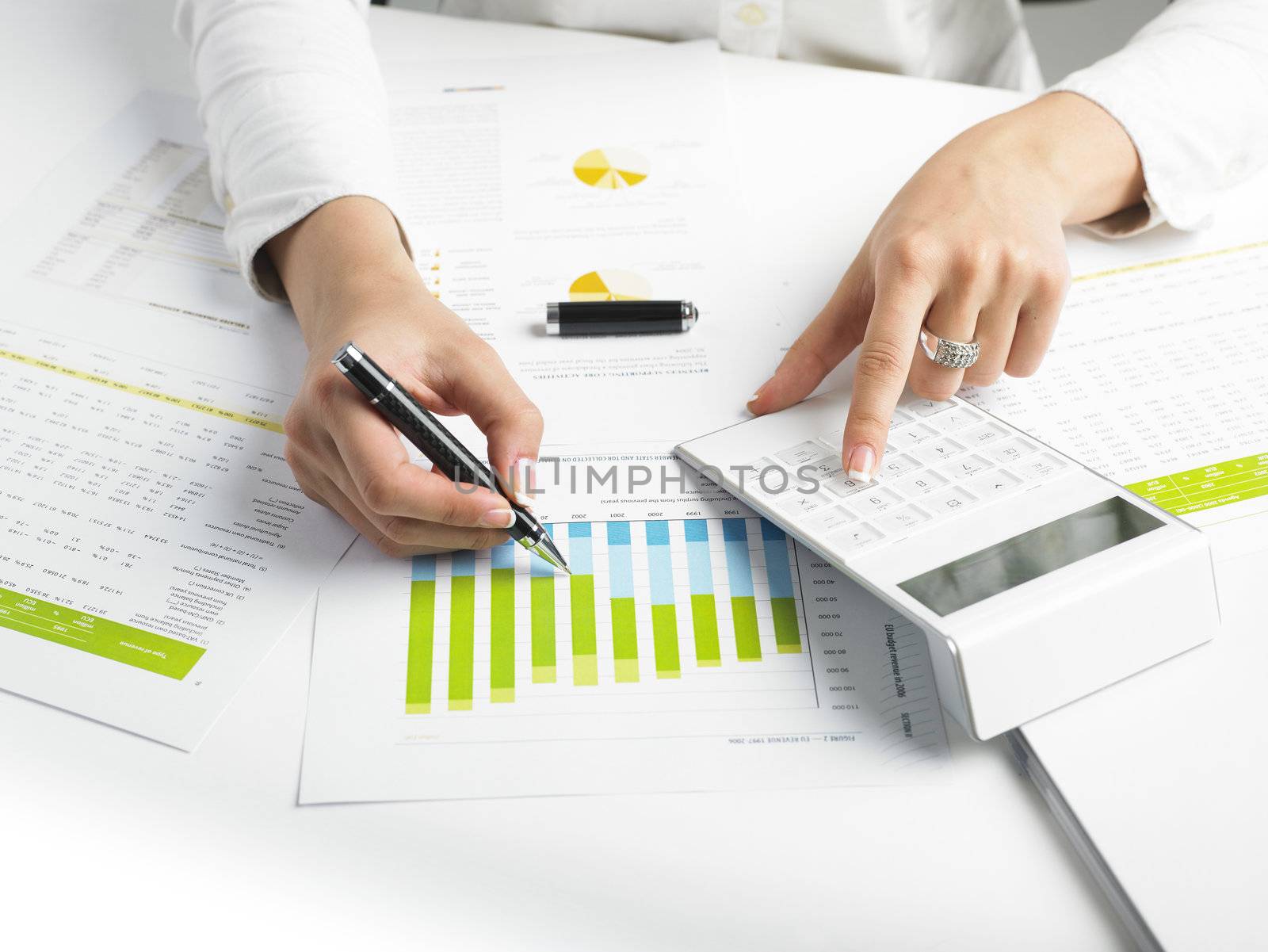 Market Analyze - pen and calculator on papers