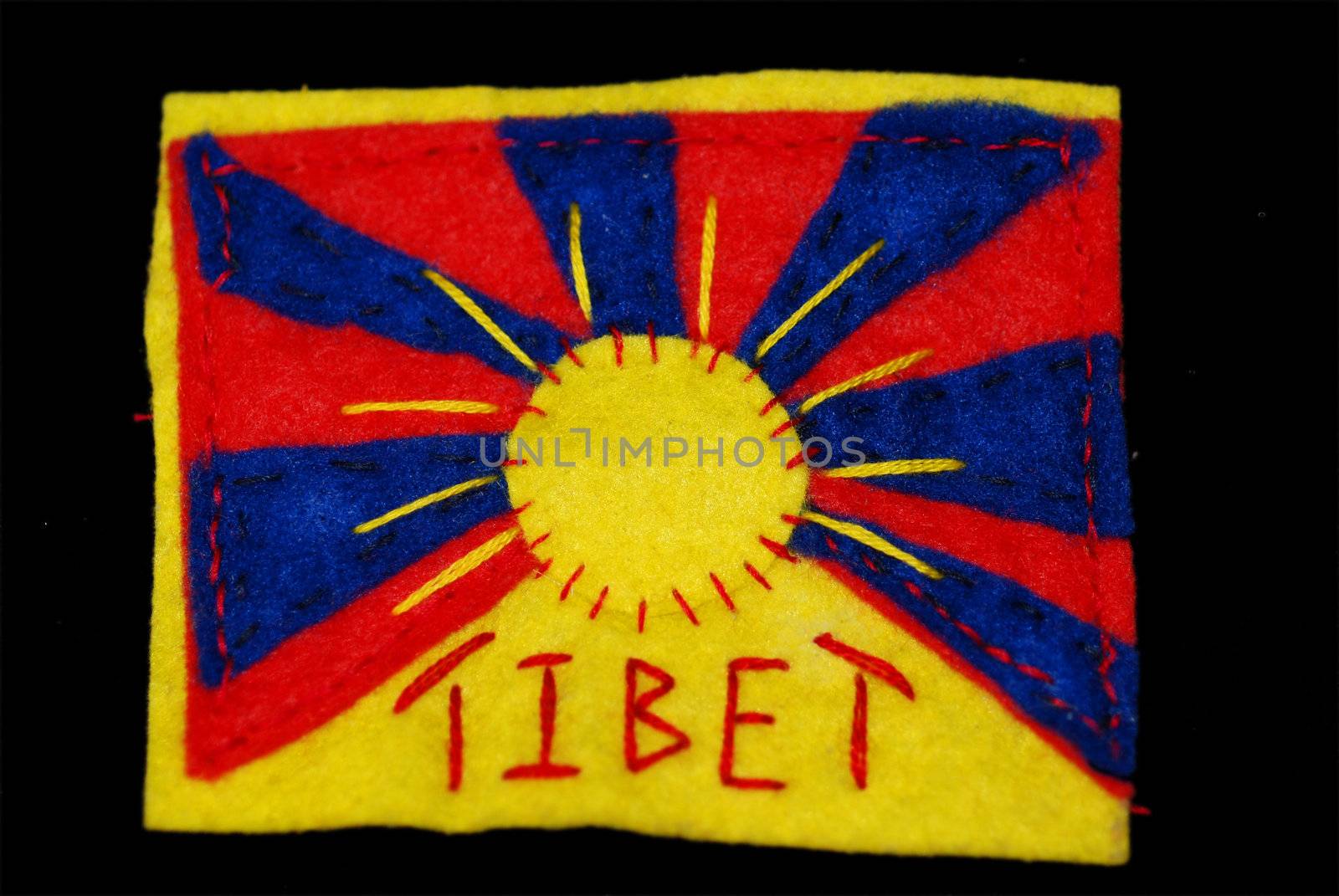 A Tibetan flag hand-sewn in felt on a black background