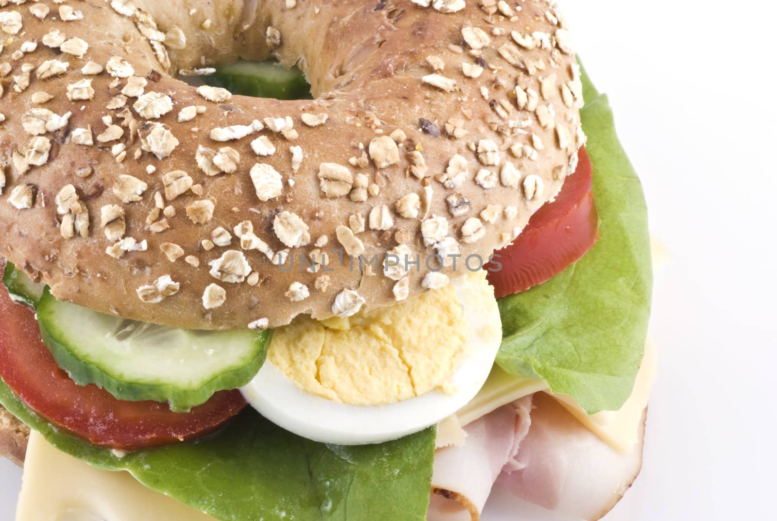 Close up of a healthy bagel sandwich on white.