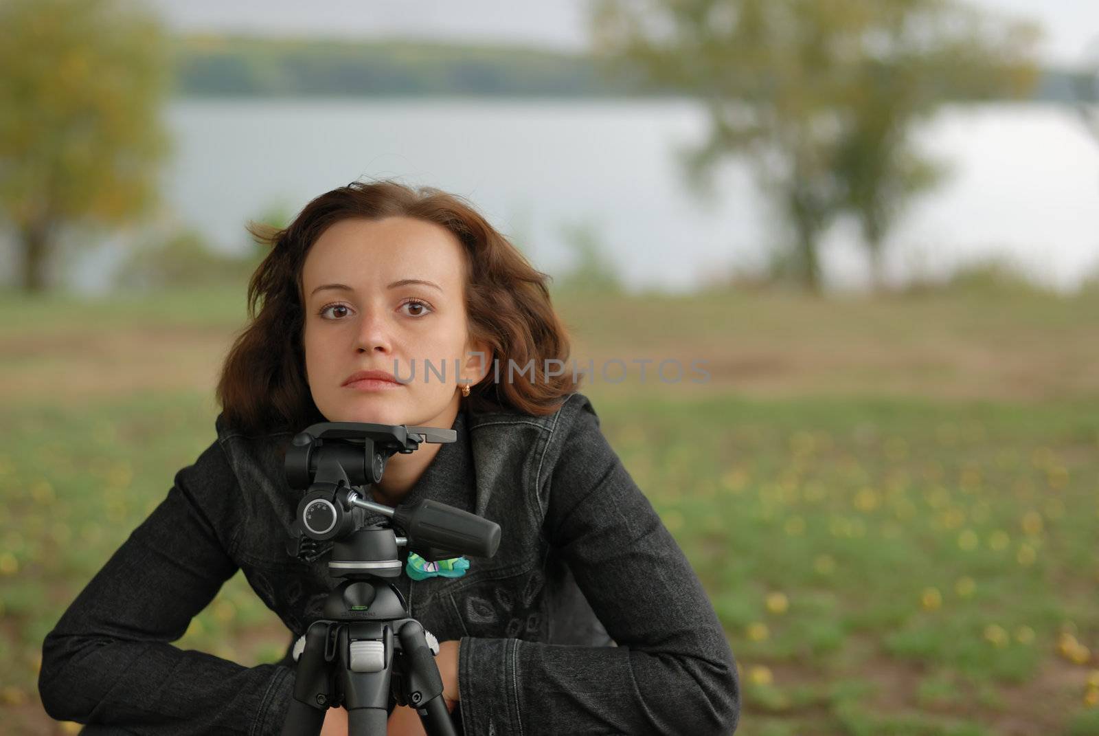 The girl - the photographer. The girl considers construction of a picture, early autumn