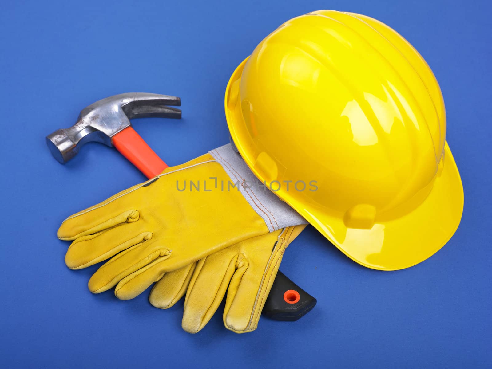 Worker equipment - HardHat Hammer And Leather Gloves on Blue