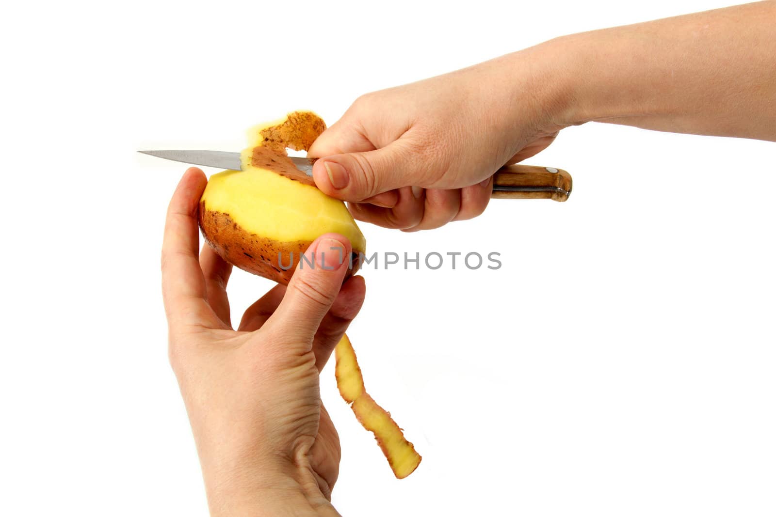 Beautiful women's hands clean potatoes peeled, isolated on a white background.