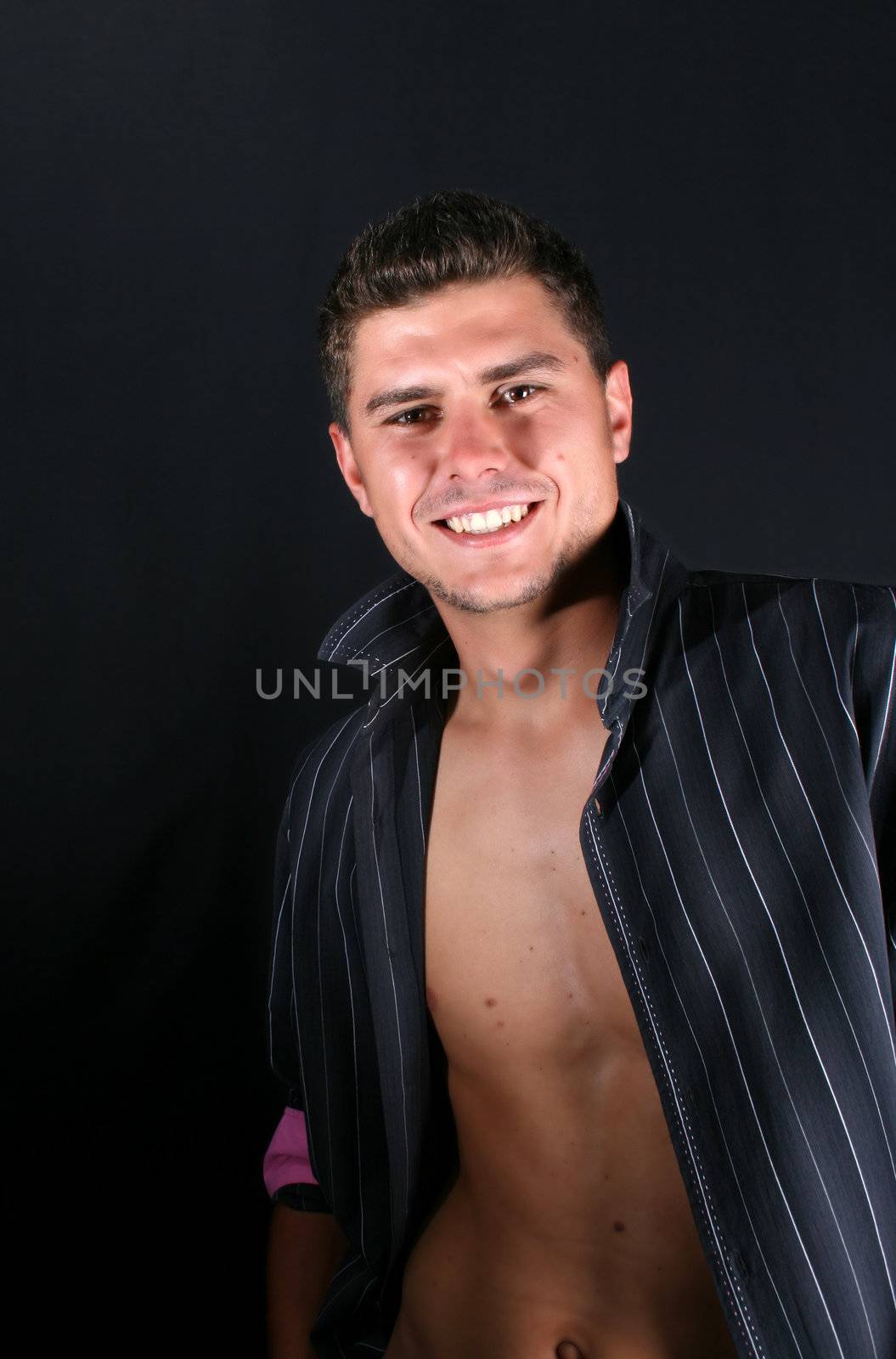 Male model in studio against black background