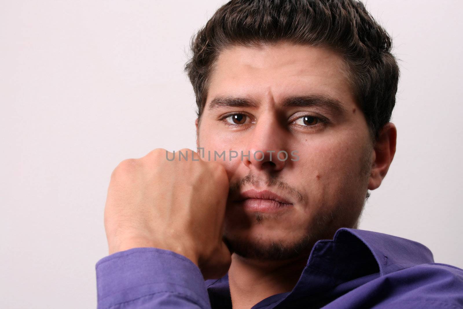 Male model in studio against white wall