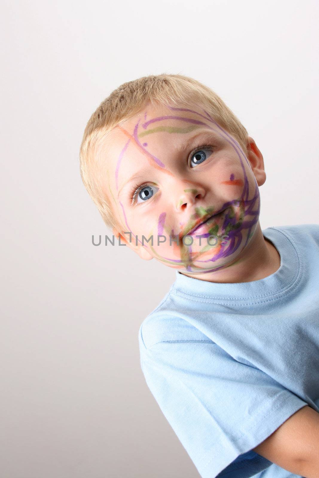Laughing Toddler playing with colored pens making a mess