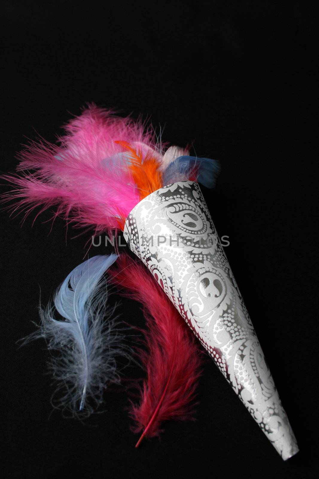 Brightly colored feather confetti in a cone