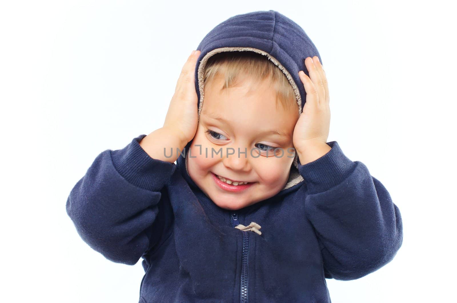 portrait of little boy in big fur hood looking at camera