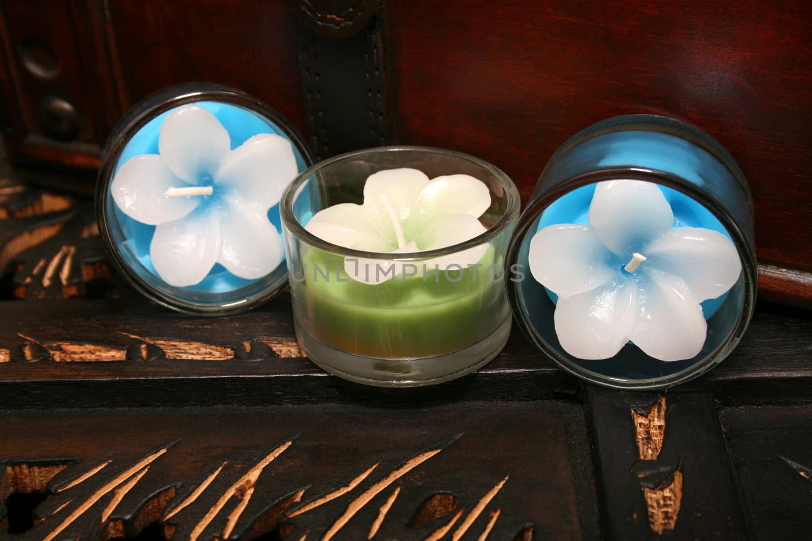 Three candles on a brown wooden surface