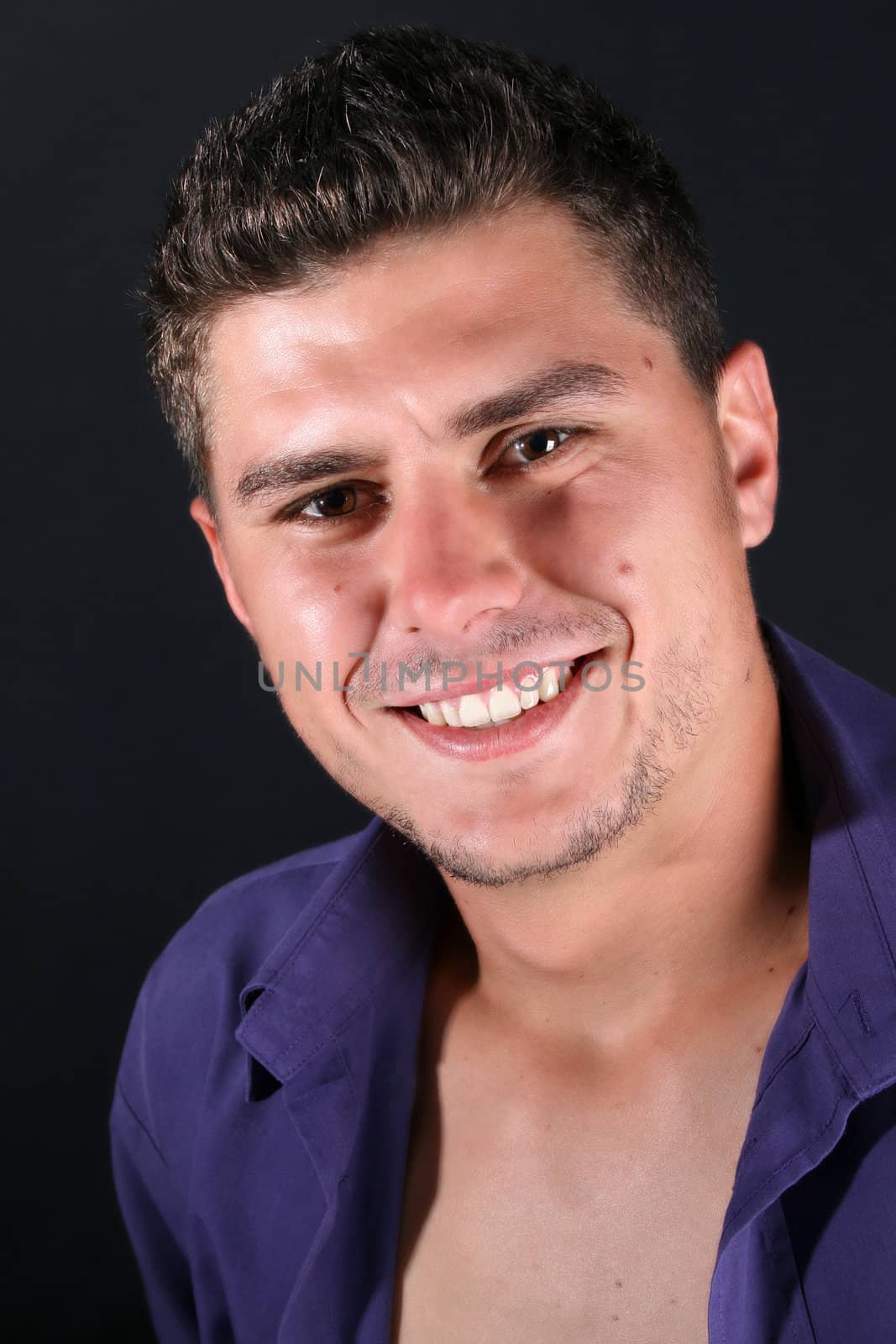 Male model in studio against black background