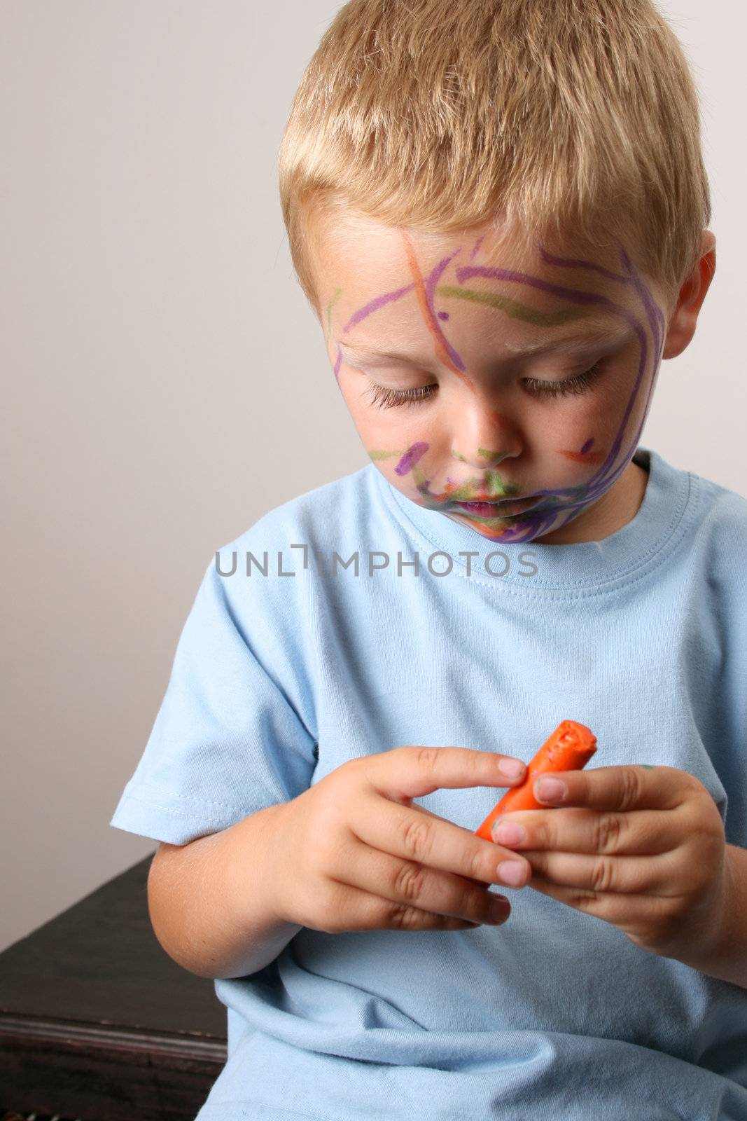 Laughing Toddler playing with colored pens making a mess