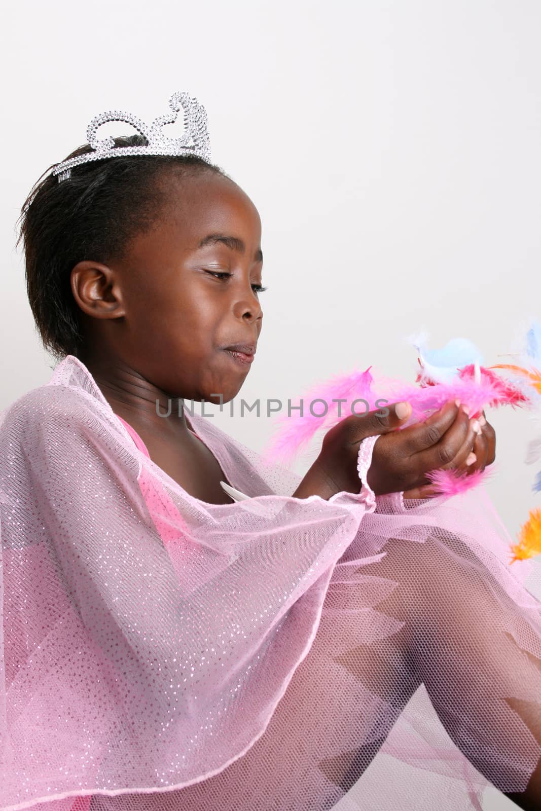 Young girl wearing a pink fairy costume with accessories