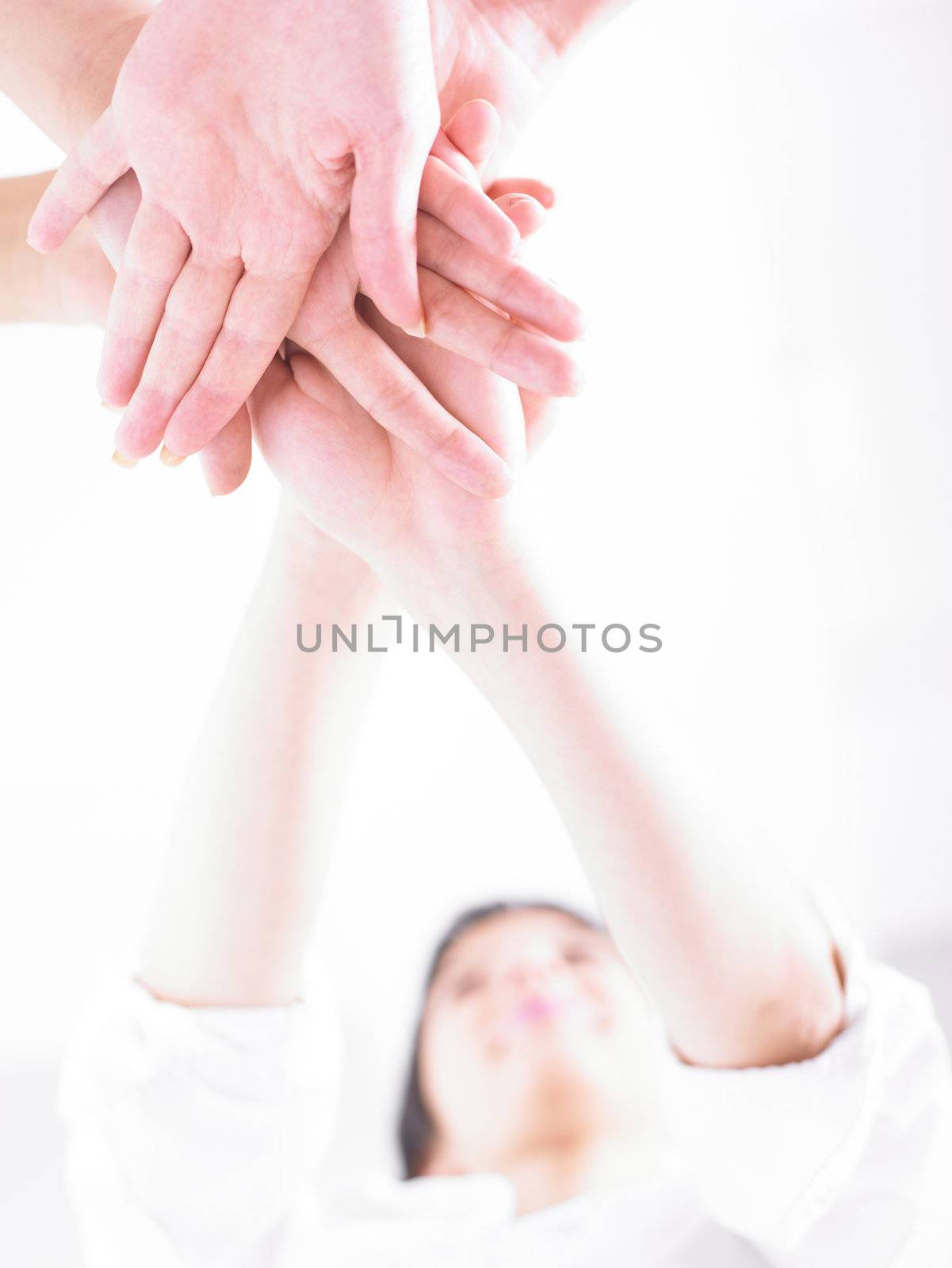 Business team join hands on white background