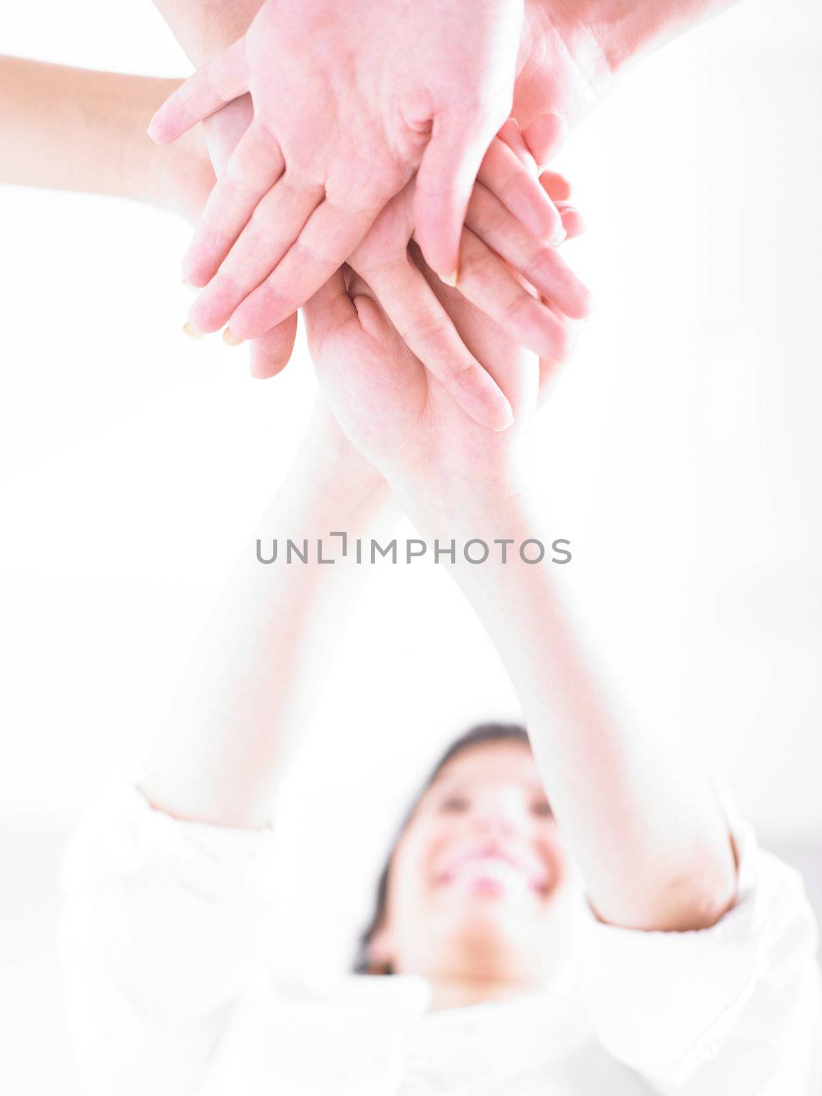 Business team join hands on white background