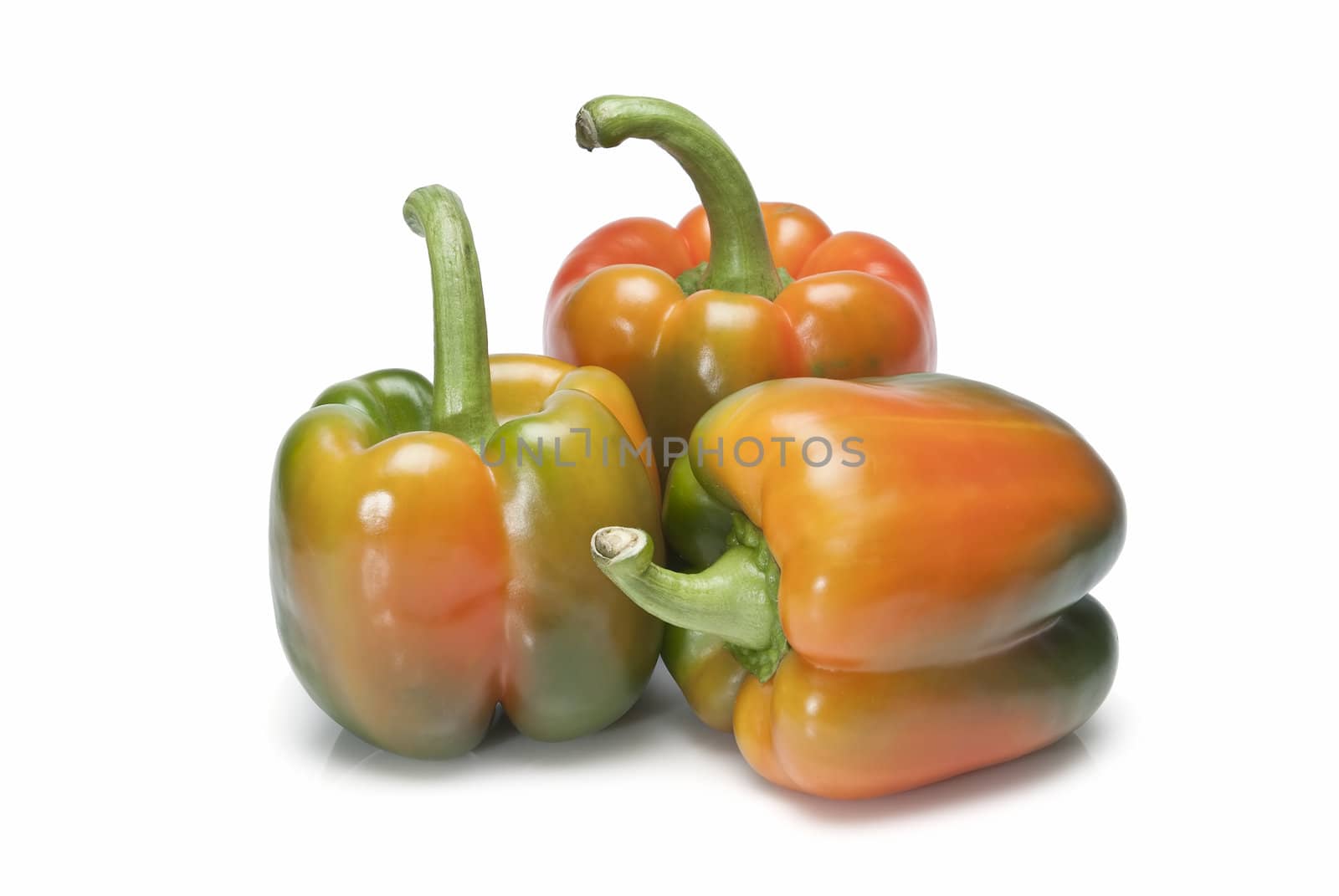 Red and green peppers isolated over a white background.