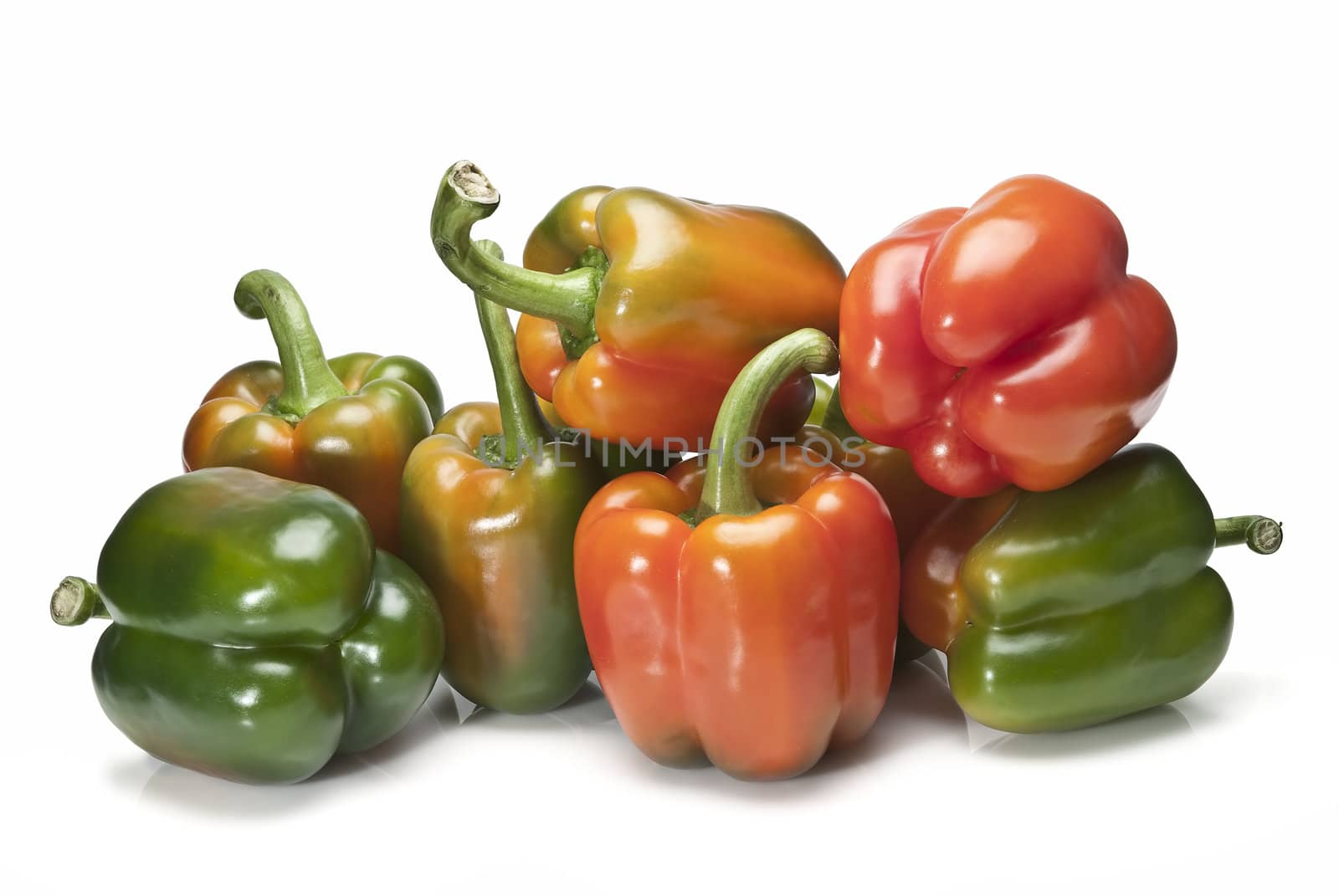 Red and green peppers isolated over a white background.