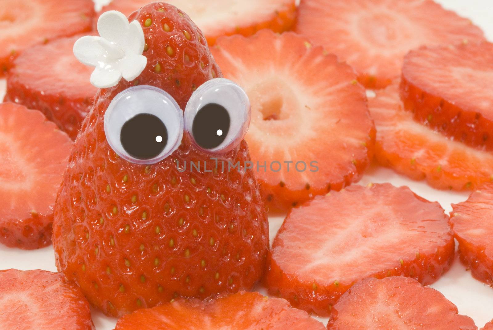 strawberry doll with a flower on her head 