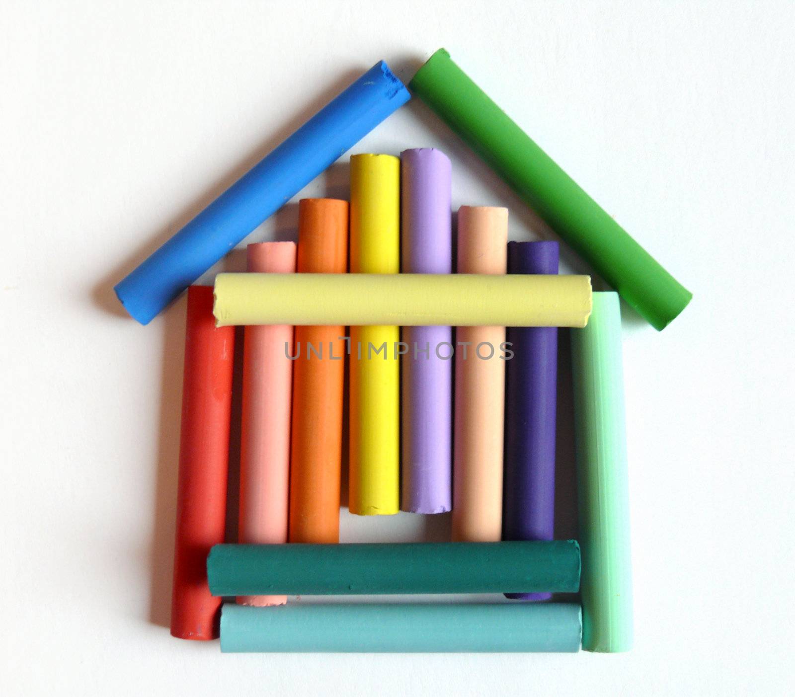 toy house made of color pastels on white paper