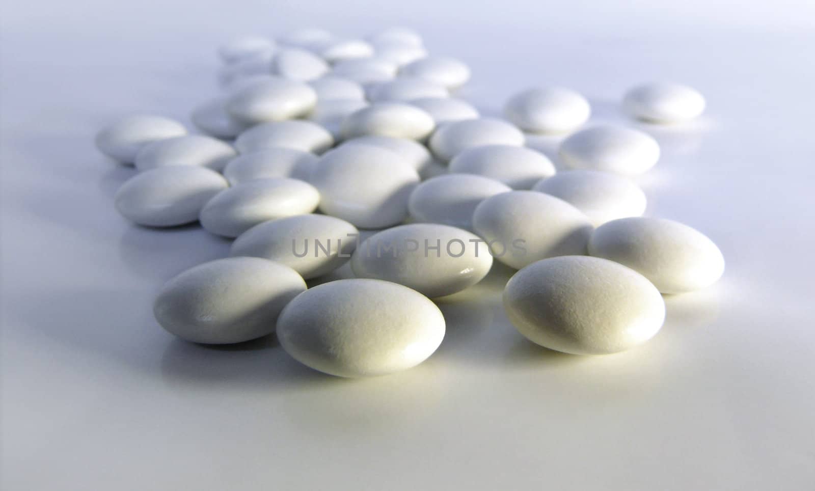 White rounded pills on white background