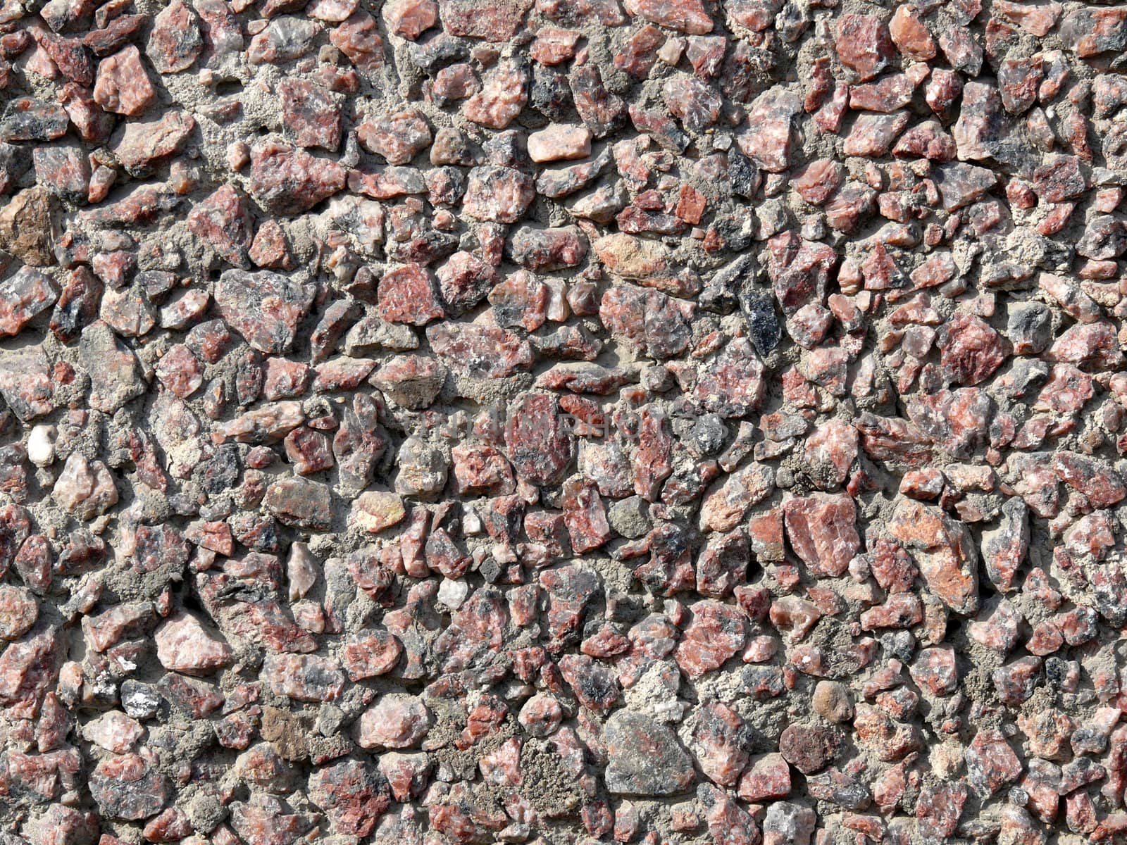 Sledged stone wall texture. Small pieses of rock.