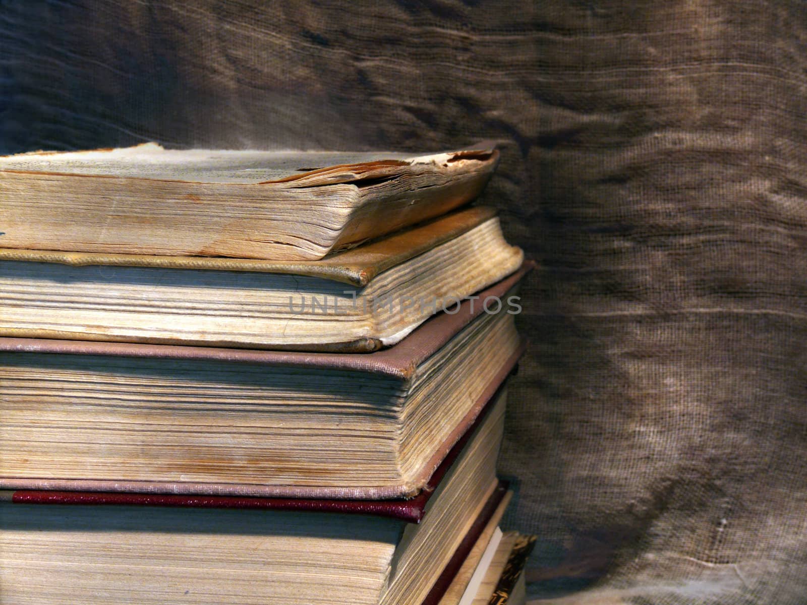 Pile of old books on the canvas background