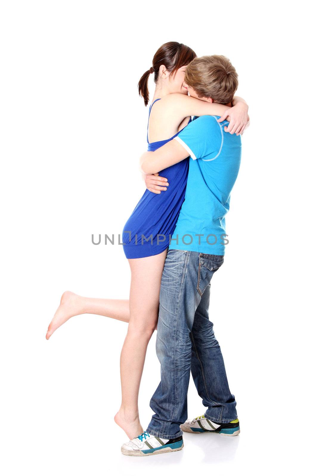 Beautiful young couple kissing against white background