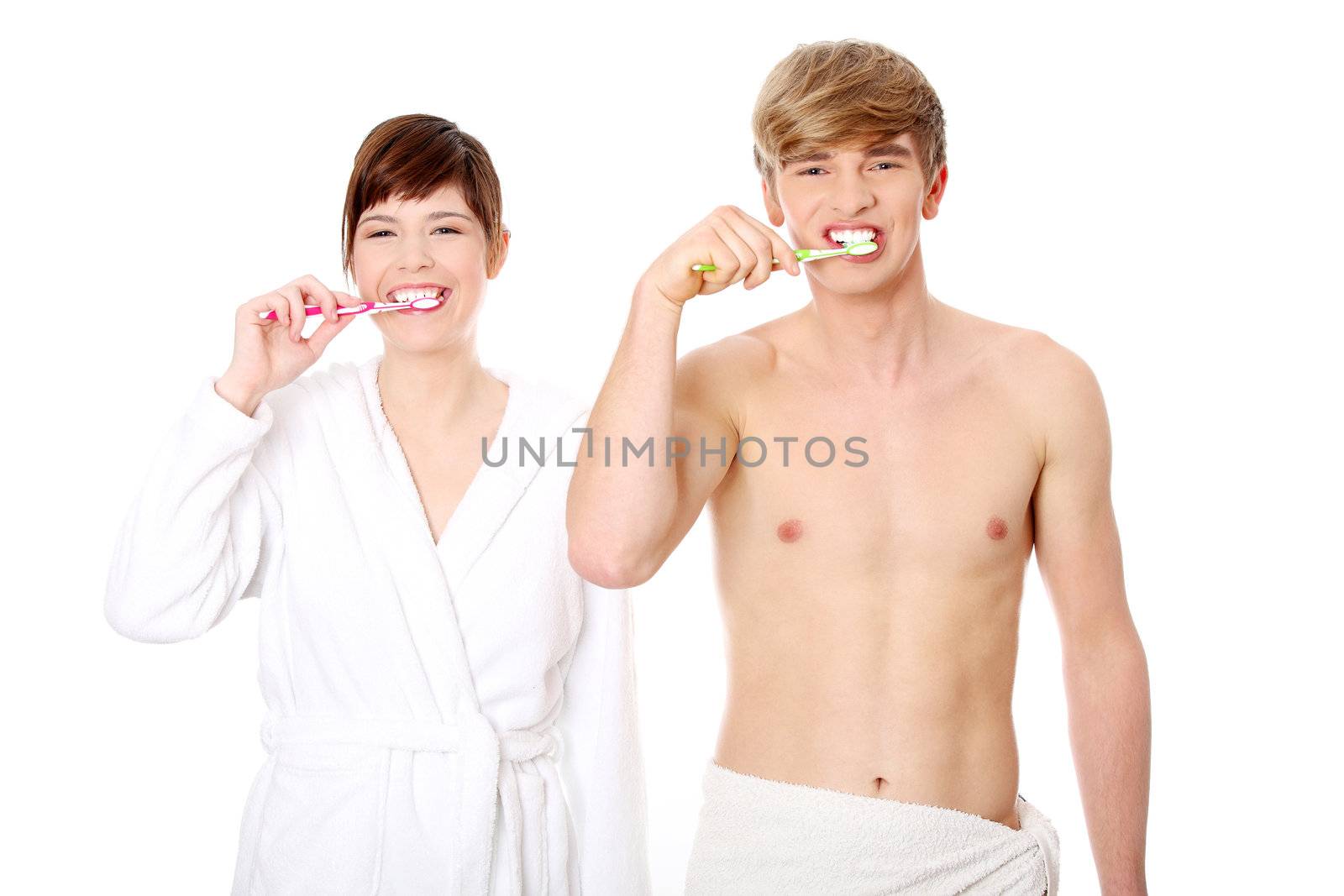 Young couple cleaning teeth together. Isolated on white